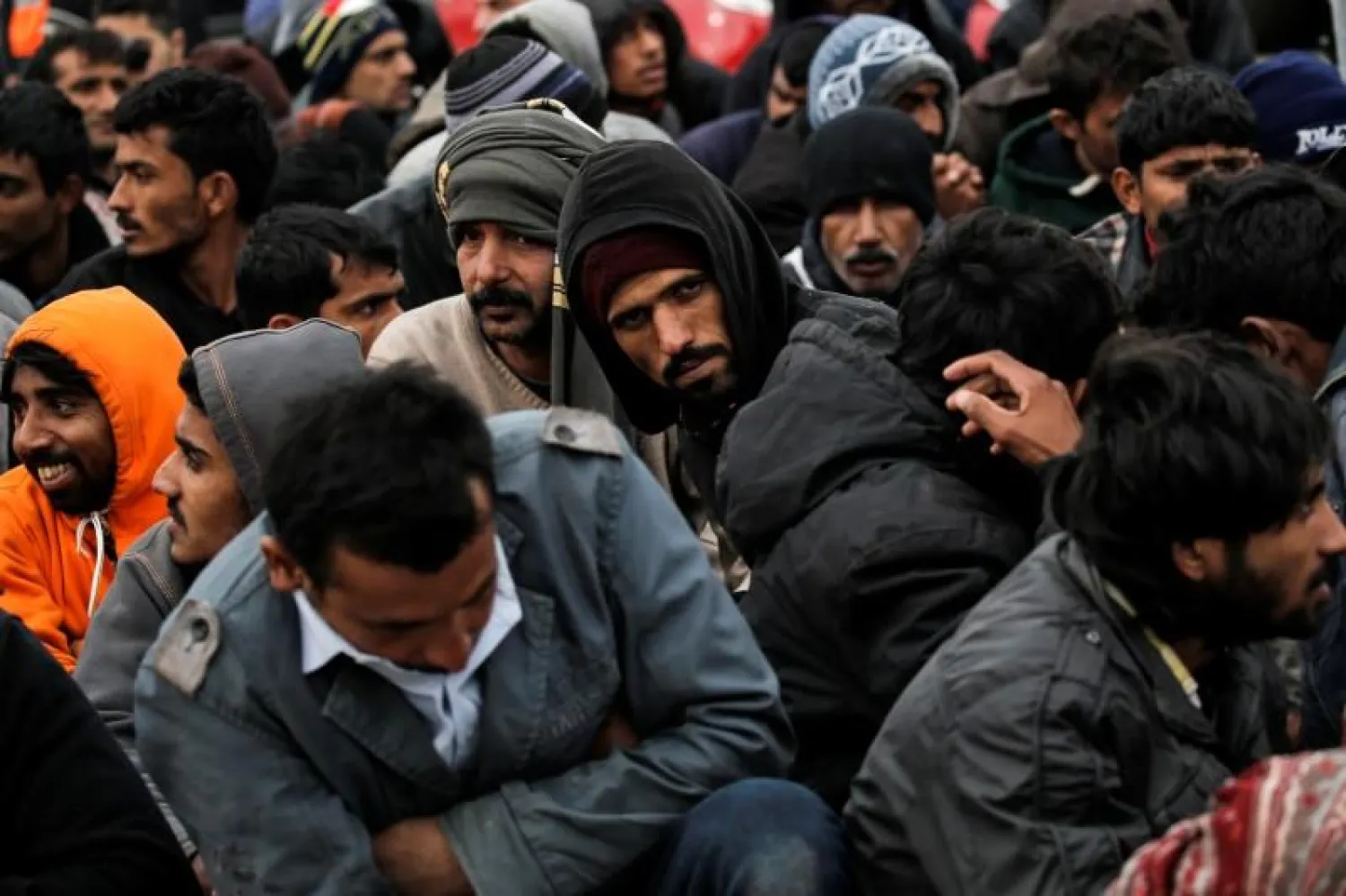 Refugees and migrants wait to be transferred to the Moria registration center after arriving at the port of Mytilene on the Greek island of Lesbos, following a rescue operation by the Greek Coast Guard at open sea, March 22, 2016. REUTERS/Alkis Konstantinidis
