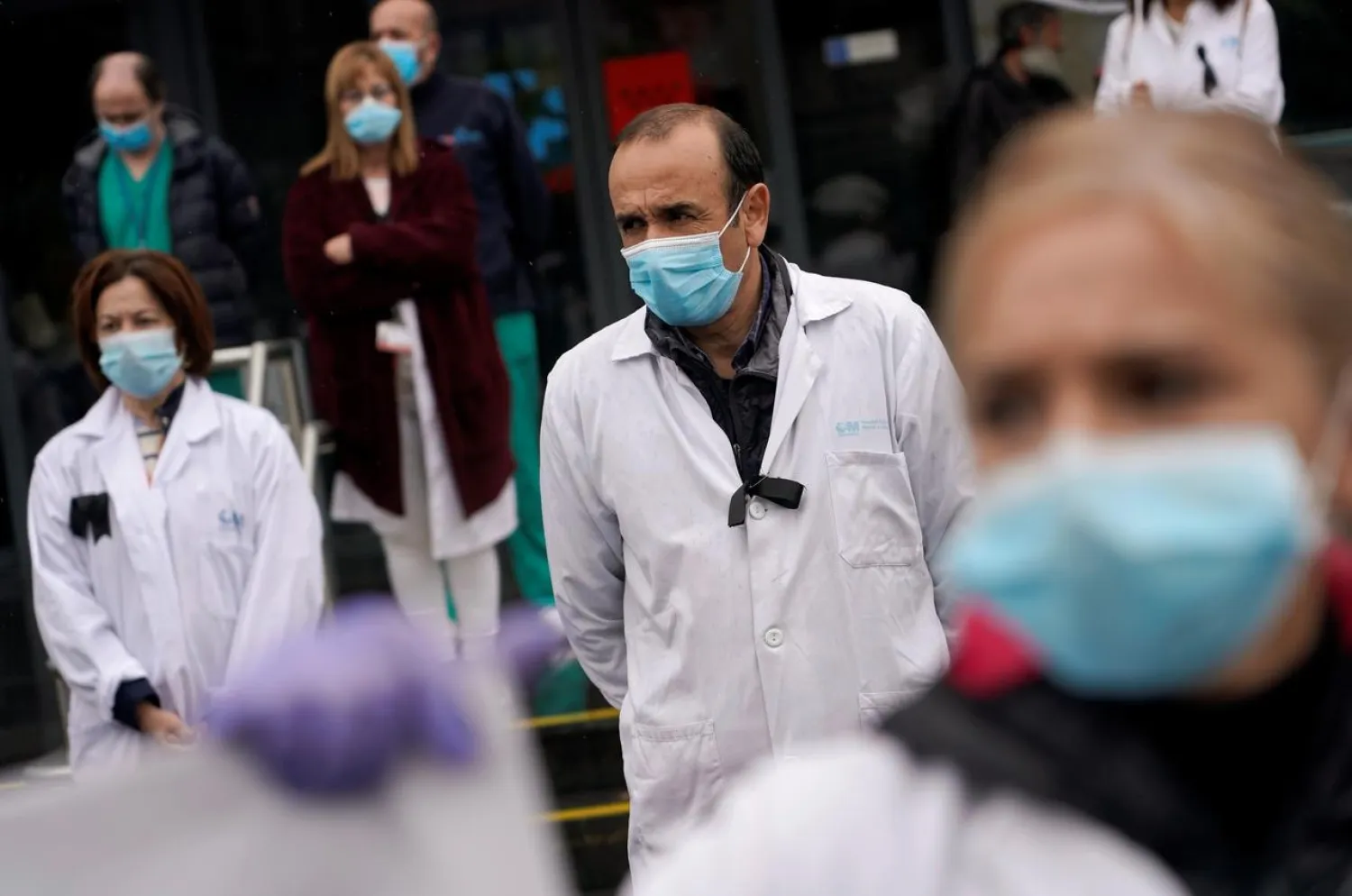 Staff from La Paz hospital react after two minutes of silence for health workers that died of COVID-19, amid the coronavirus disease (COVID-19) outbreak in Madrid, Spain, May 14, 2020. REUTERS/Juan Medina
