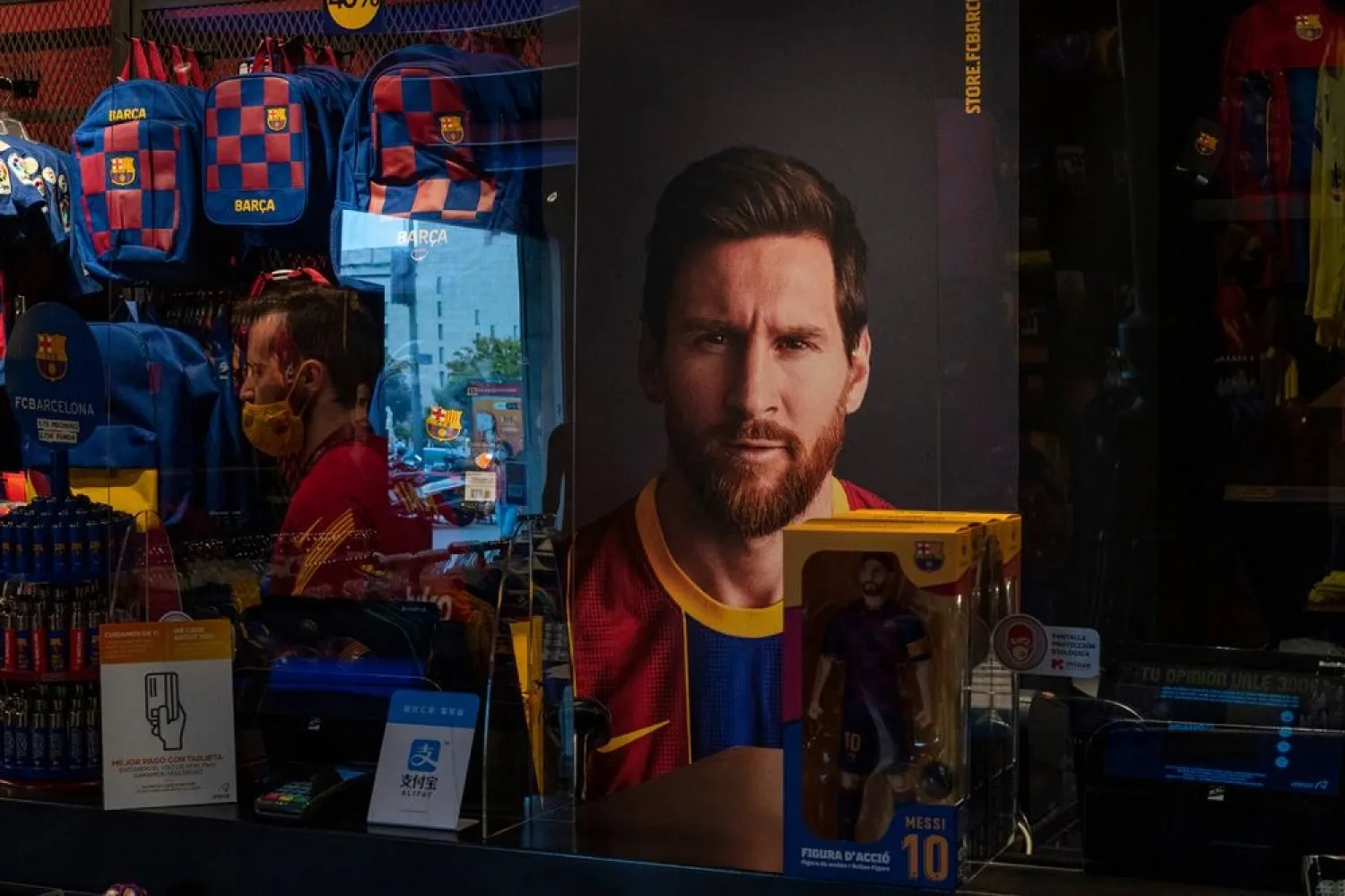 A poster with the face of Barcelona player Lionel Messi is displayed at a FC Barcelona store in Barcelona, Spain on Tuesday, Sept. 1, 2020. (AP)