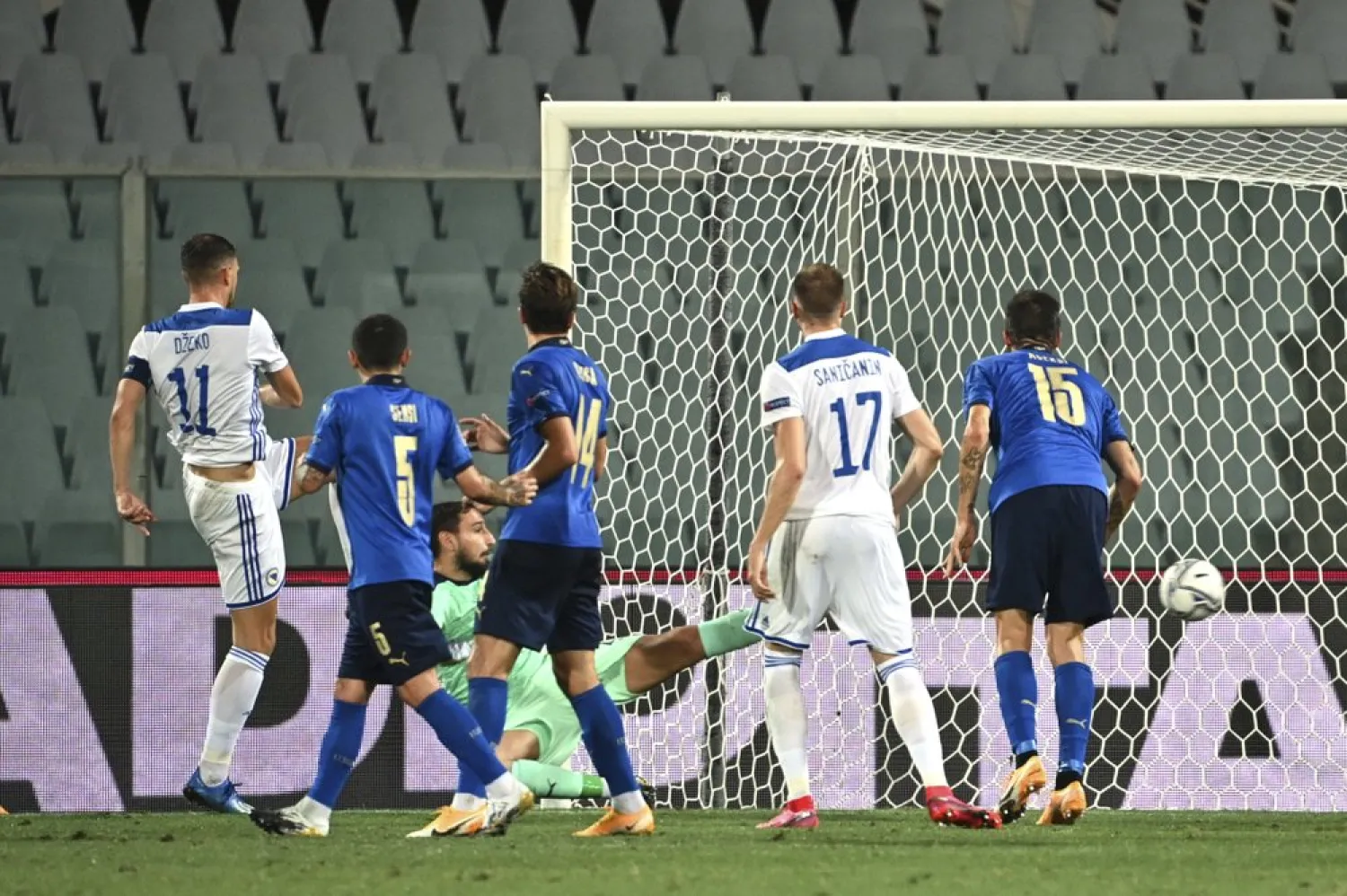 Bosnia Herzegovina's Edin Dzeko, left, scores during the UEFA Nations League soccer match between Italy and Bosnia Herzegovina, at the Artemio Franchi Stadium in Florence, Italy, Friday, Sept. 4, 2020. (AP)