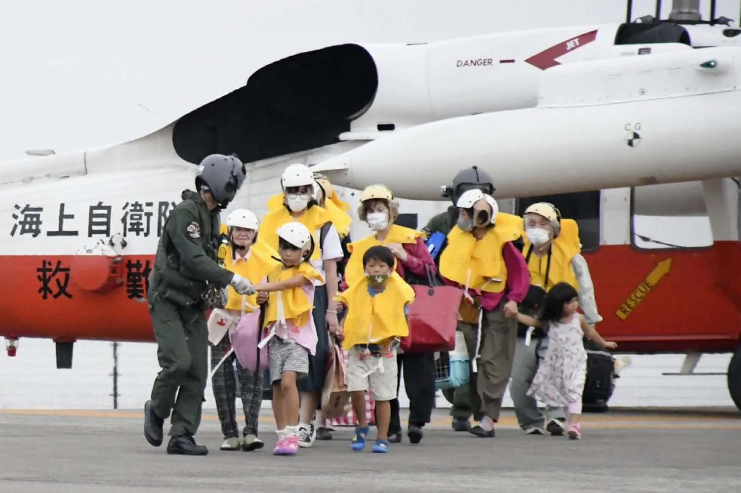 Residents of the islands arrive at a heliport in Kagoshima, southern Japan Friday, Sept. 4, 2020 to take refuge ahead of a powerful typhoon. (AP)