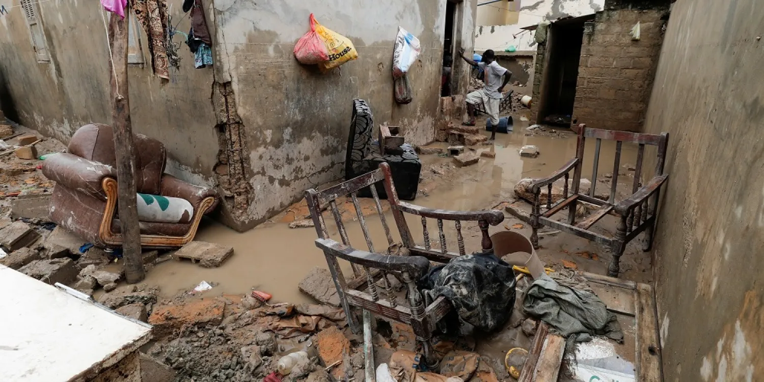 A man stands at a house's flooded courtyard after heavy rains in the Ndiaga Mbaye district on the outskirts of Dakar, Senegal, Sept. 6, 2020. (Reuters)
