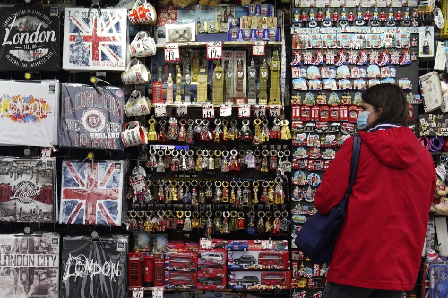 A tourist looks at souvenirs on sale in Central London, Britain, 27 August 2020. (EPA)