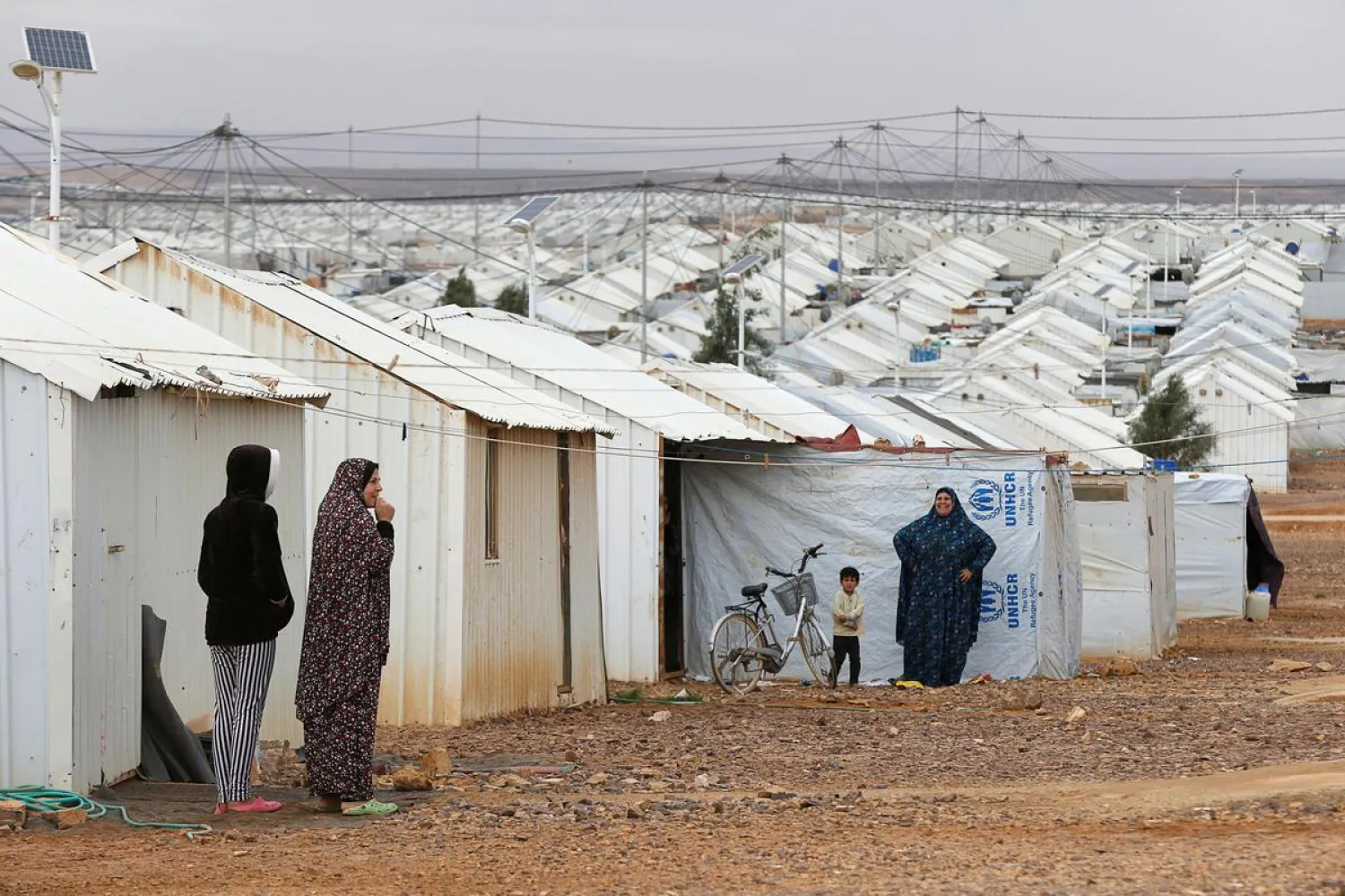 Syrian refugee women stand in front of their homes at Azraq refugee camp, near Al Azraq city, Jordan, December 8, 2018. (Reuters)
