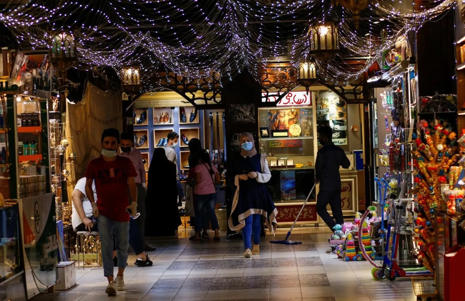 Iraqi people wearing protective masks are seen at a shopping mall after malls reopened, as the coronavirus restrictions are eased, in Baghdad, Iraq July 19, 2020. (Reuters)