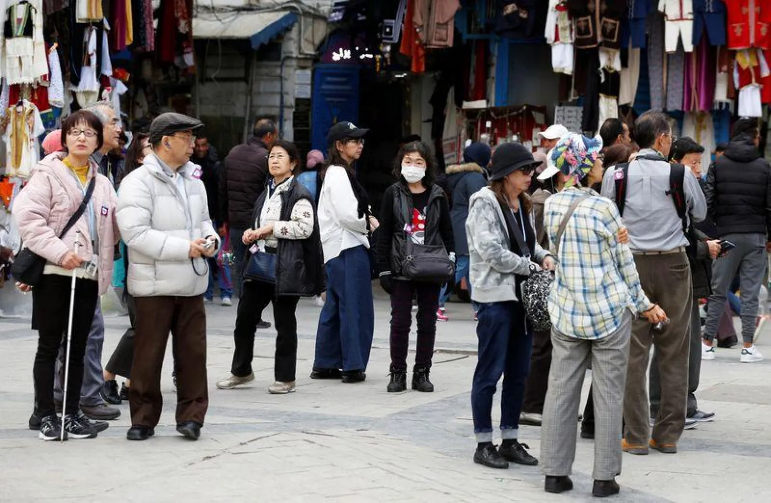 Tourists walk, one of them wearing a protective face mask, in the Old City of Tunis. REUTERS/Zoubeir Souissi