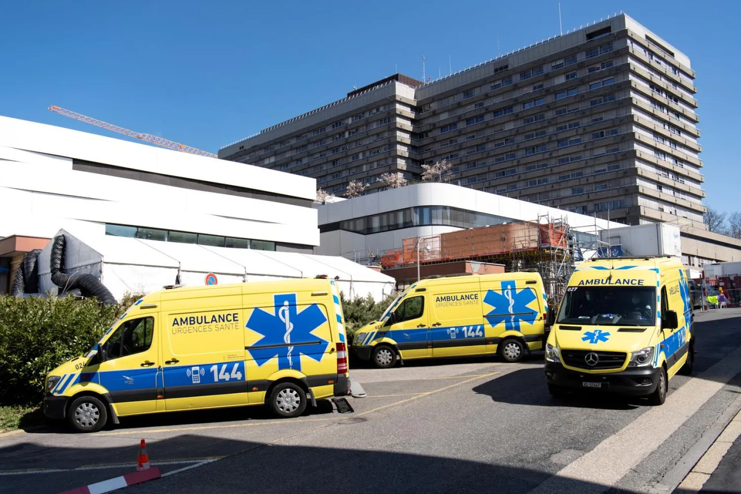 FILE PHOTO: Ambulances are pictured in front of a temporary space for patients at the University Hospital (CHUV) during the coronavirus outbreak in Lausanne, Switzerland, March 31, 2020. Laurent Gillieron/Pool via REUTERS/File Photo
