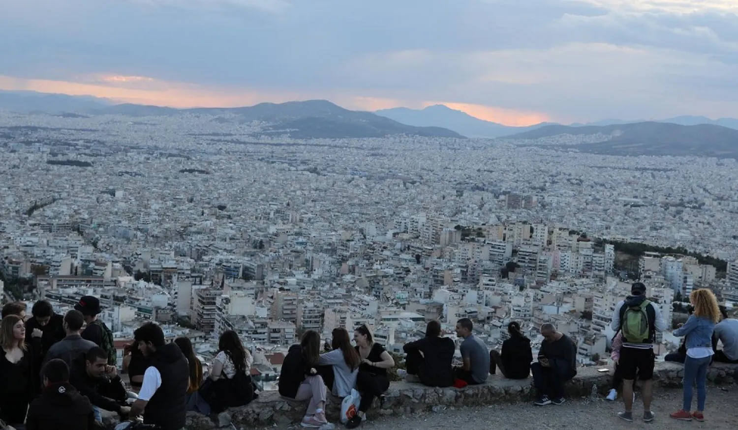 People sit overlooking Athens following the coronavirus disease (COVID-19) outbreak, Greece, May 3, 2020. (Reuters)