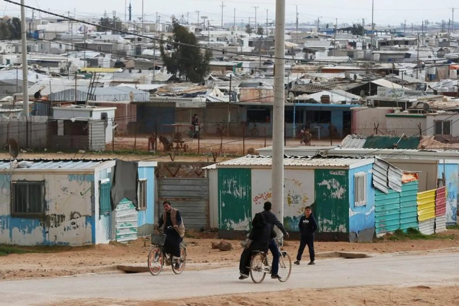 Syrian refugees ride their bicycles in the Zaatari refugee camp near the border city of Mafraq, Jordan February 1, 2020. (Reuters)