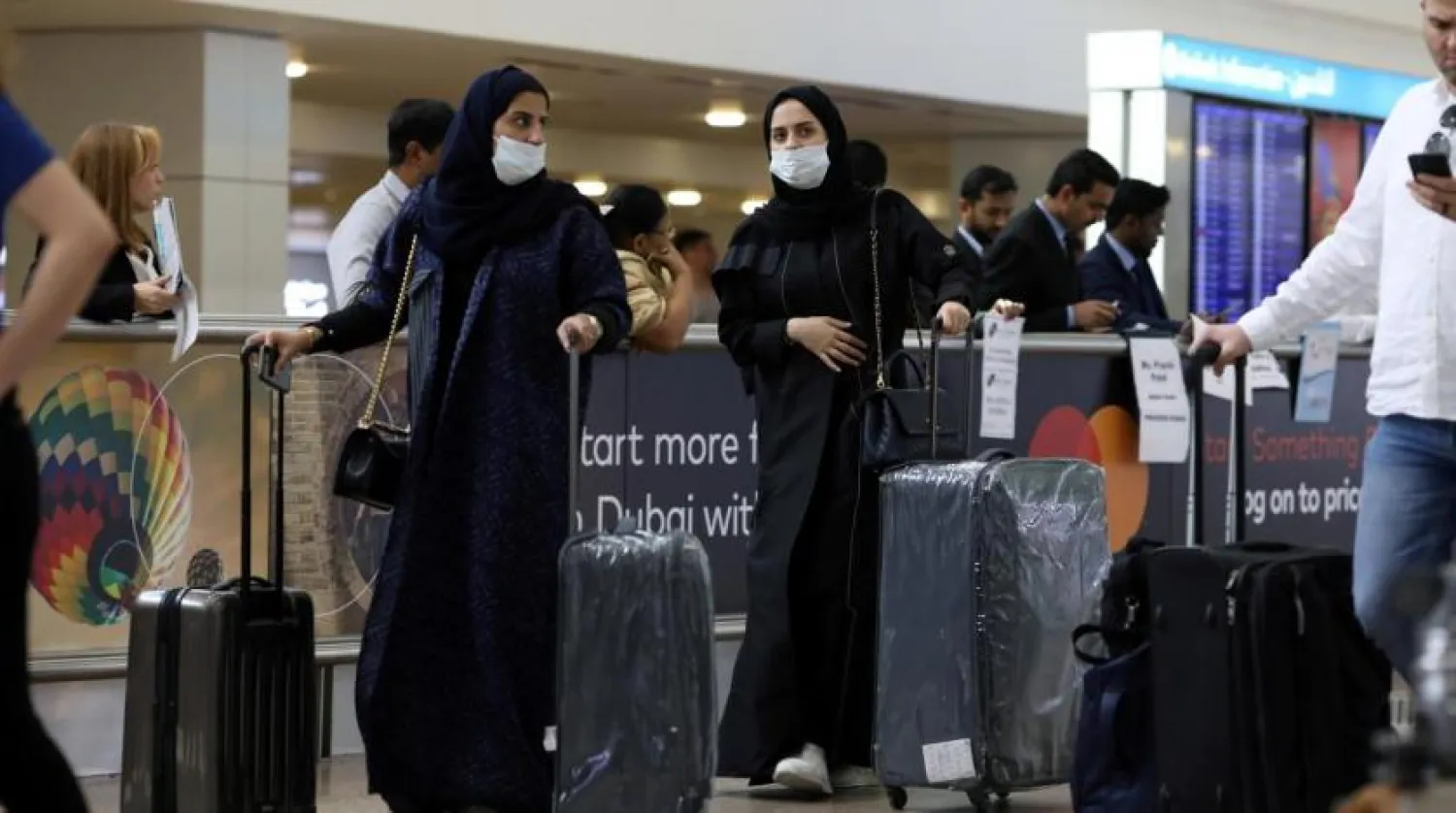 FILE PHOTO: Travelers wear masks as they arrive at the Dubai International Airport, in Dubai, United Arab Emirates January 29, 2020. REUTERS/Christopher Pike
