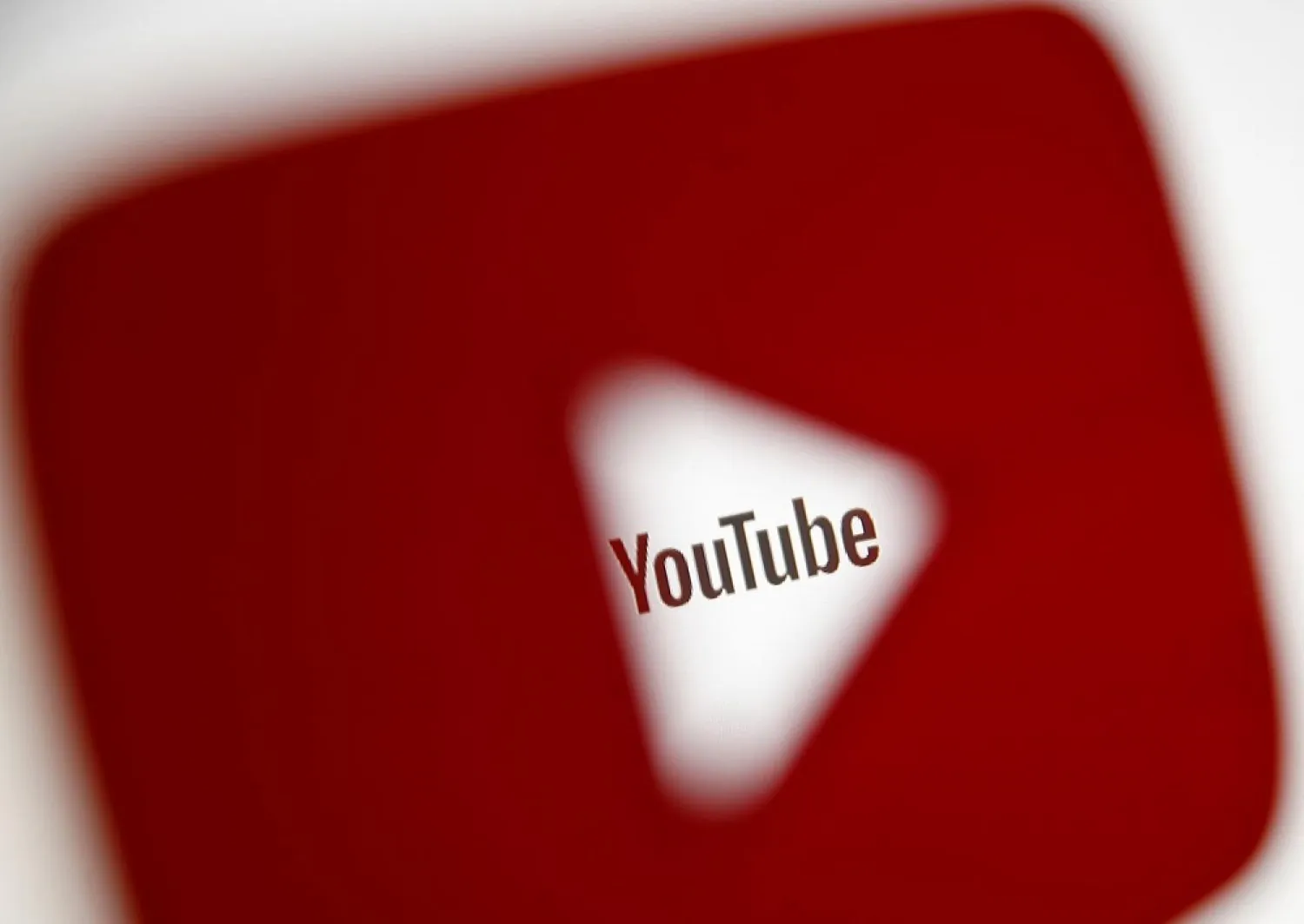 A 3D-printed YouTube icon is seen in front of a displayed YouTube logo in this illustration taken October 25, 2017. (Reuters)
