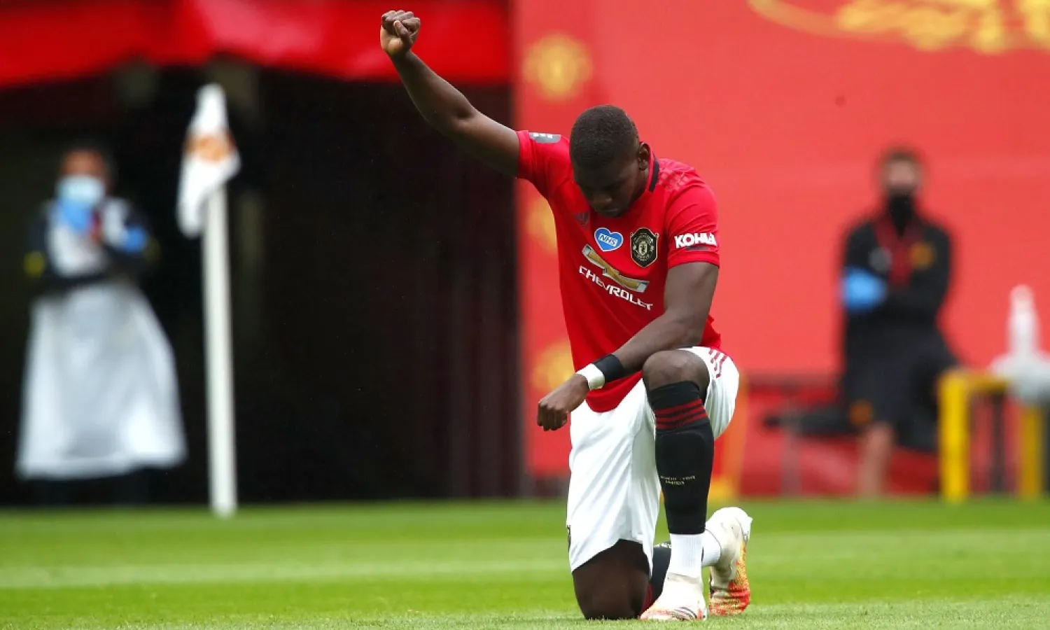 Manchester United’s Paul Pogba takes a knee and gestures in support of the Black Lives Matter movement prior to the Premier League match against Bournemouth in July. (AP)