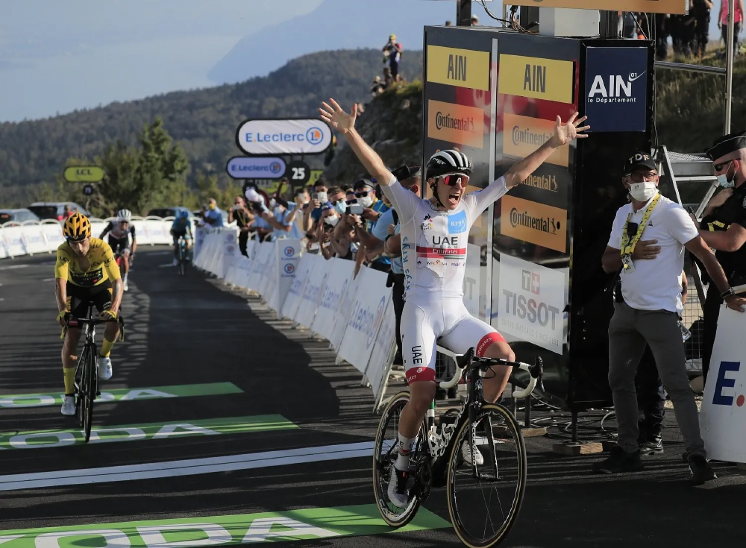 Slovenia's Tadej Pogacar crosses the finish line ahead of Slovenia's Primoz Roglic, left, to win stage 15 of the Tour de France cycling race over from Lyon to Grand Colombier pass, France, Sept. 13, 2020. (AP)