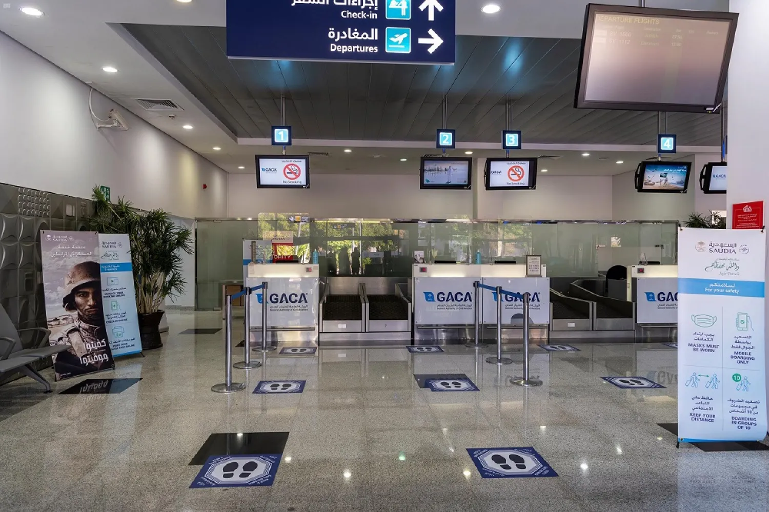 Signs indicating safe social distances between travelers are seen at an airport in Saudi Arabia. (SPA)