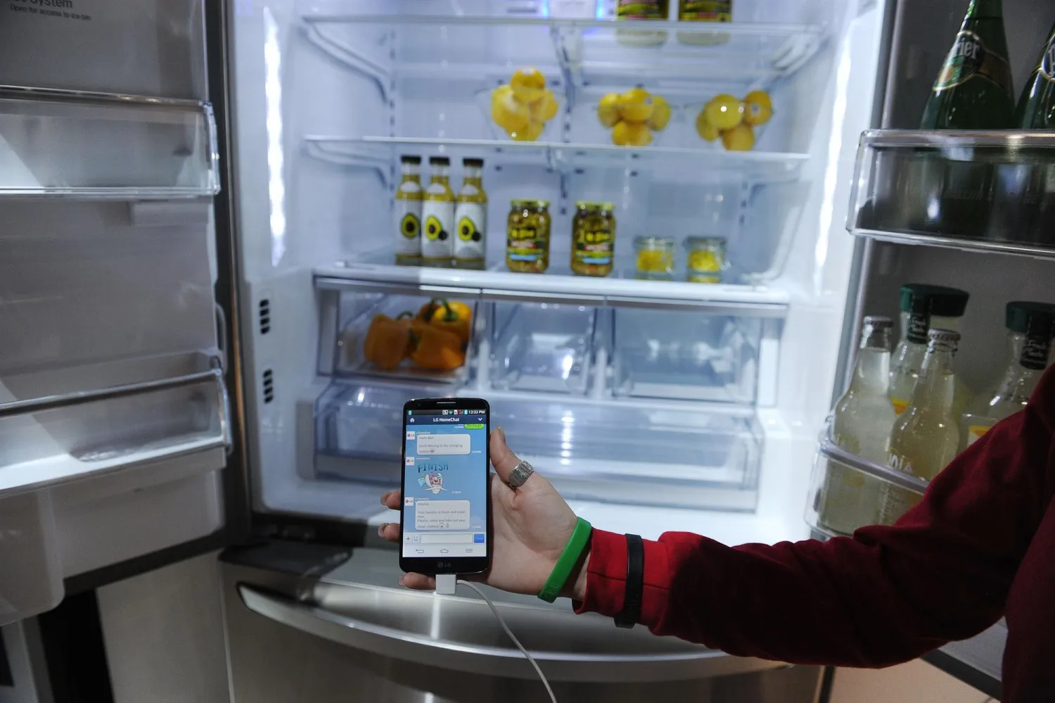 A LG representative shows a smartphone with Home Chat in front
of a LG smart refrigerator on the final day of the 2014 International
CES, January 10, 2014 in Las Vegas, Nevada. ROBYN BECK / AFP - Getty
Images file