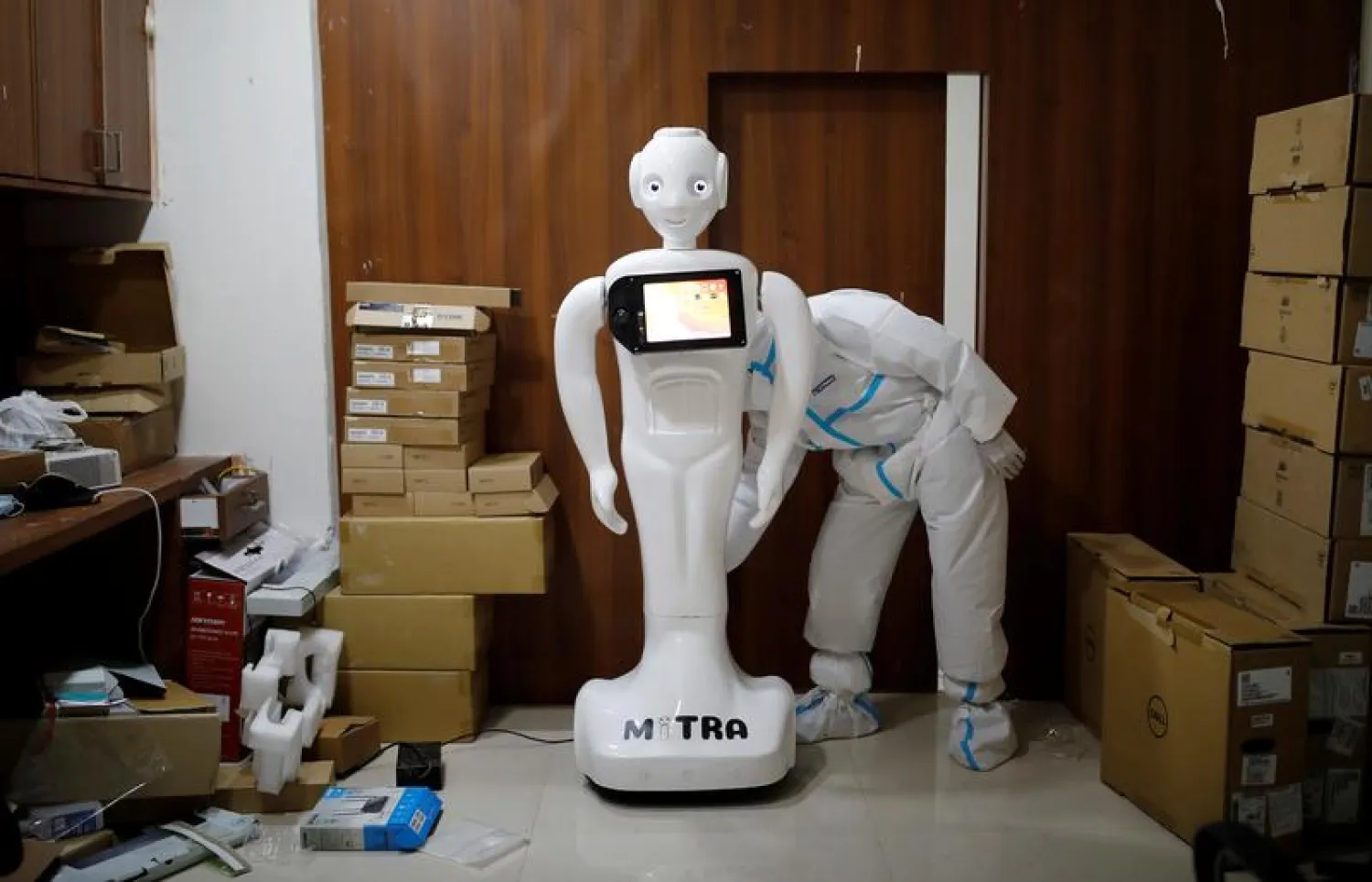 A medical worker puts robot named 'Mitra' on charge at the Yatharth Super Specialty Hospital in Noida, on the outskirts of New Delhi, India, September 15, 2020. (Reuters)