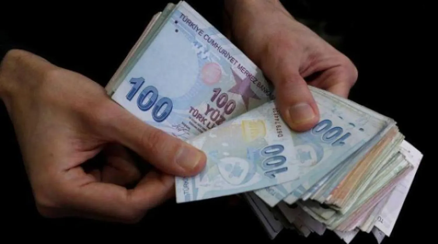 İstanbul'da bir adam Türk Lirası banknot hazırlıyor (Arşiv - Reuters)
