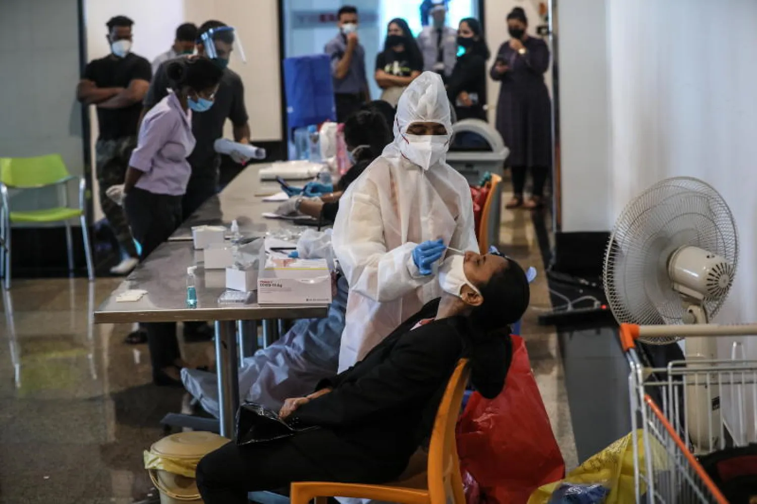 موظفة بمركز تجاري في مومباي بالهند تخضع لاختبار الكشف عن «كورونا» (إ.ب.أ)