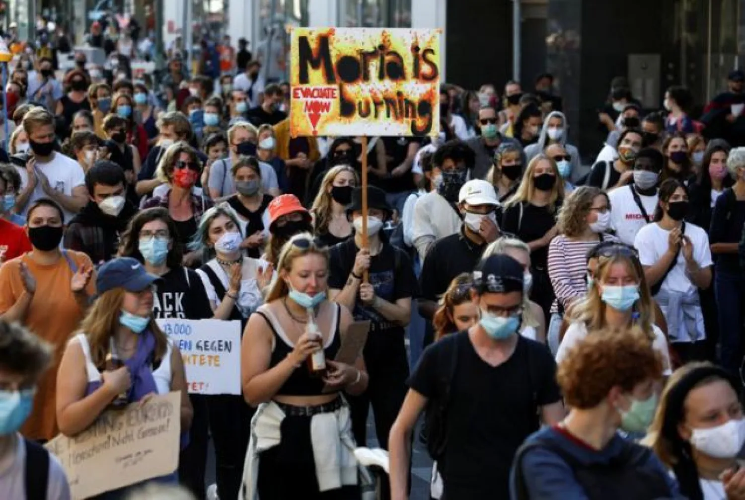 Protesters attend a demonstration demanding the evacuation of Greek overcrowded migrant camps and against the creation of a new camp on the Aegean island of Lesbos, in Berlin, Germany September 20, 2020. REUTERS/Christian Mang