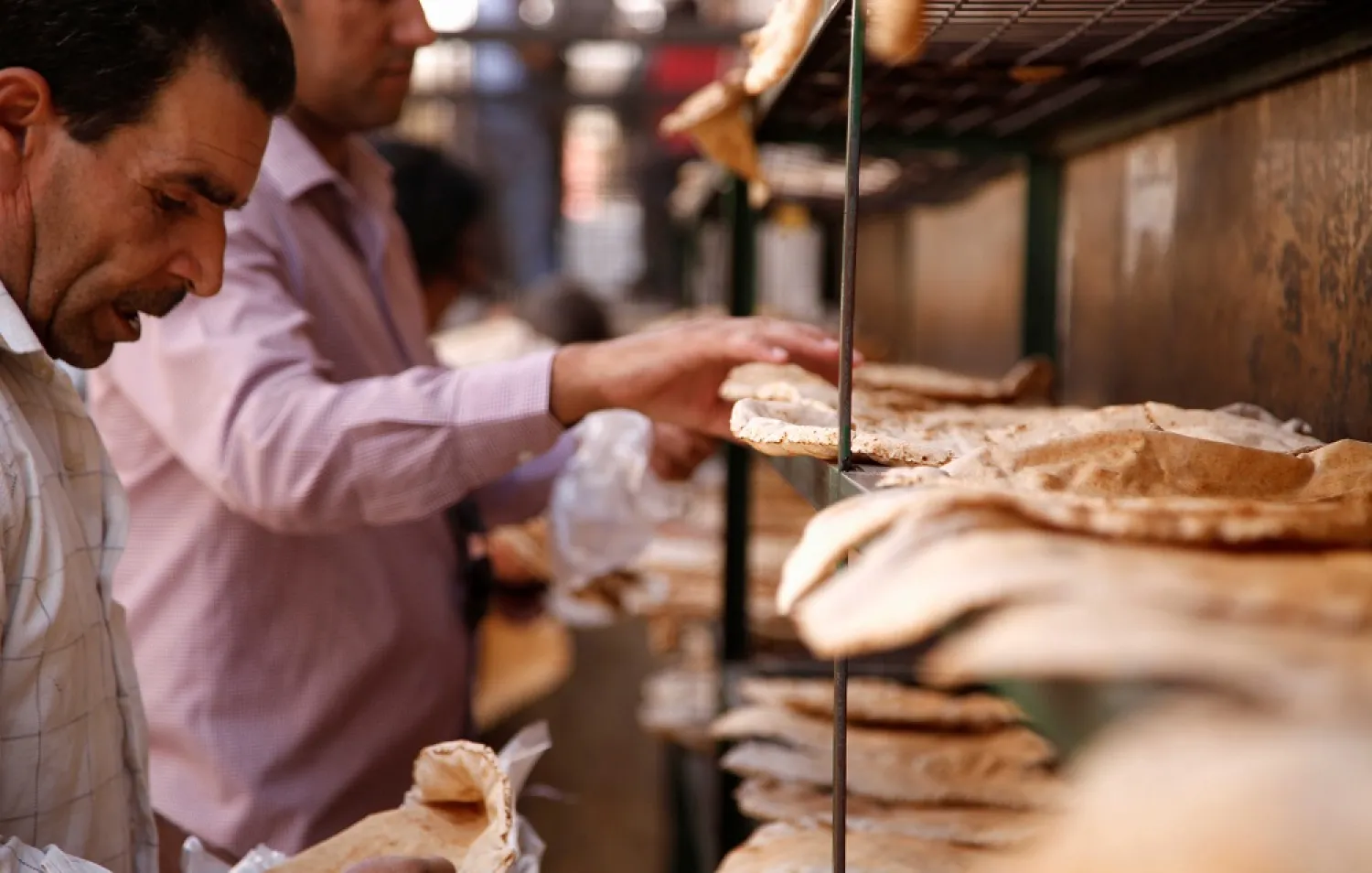 Men arrange bread to cool down in Damascus, Syria. (Reuters)