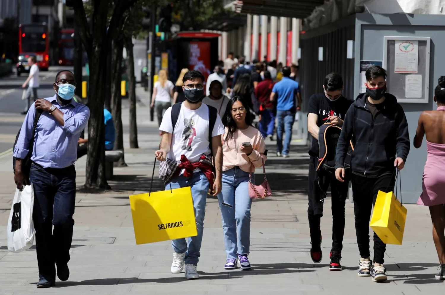 Pedestrians carry shopping bags, amid the coronavirus disease (COVID-19) outbreak, in London, Britain, July 18, 2020. (Reuters)