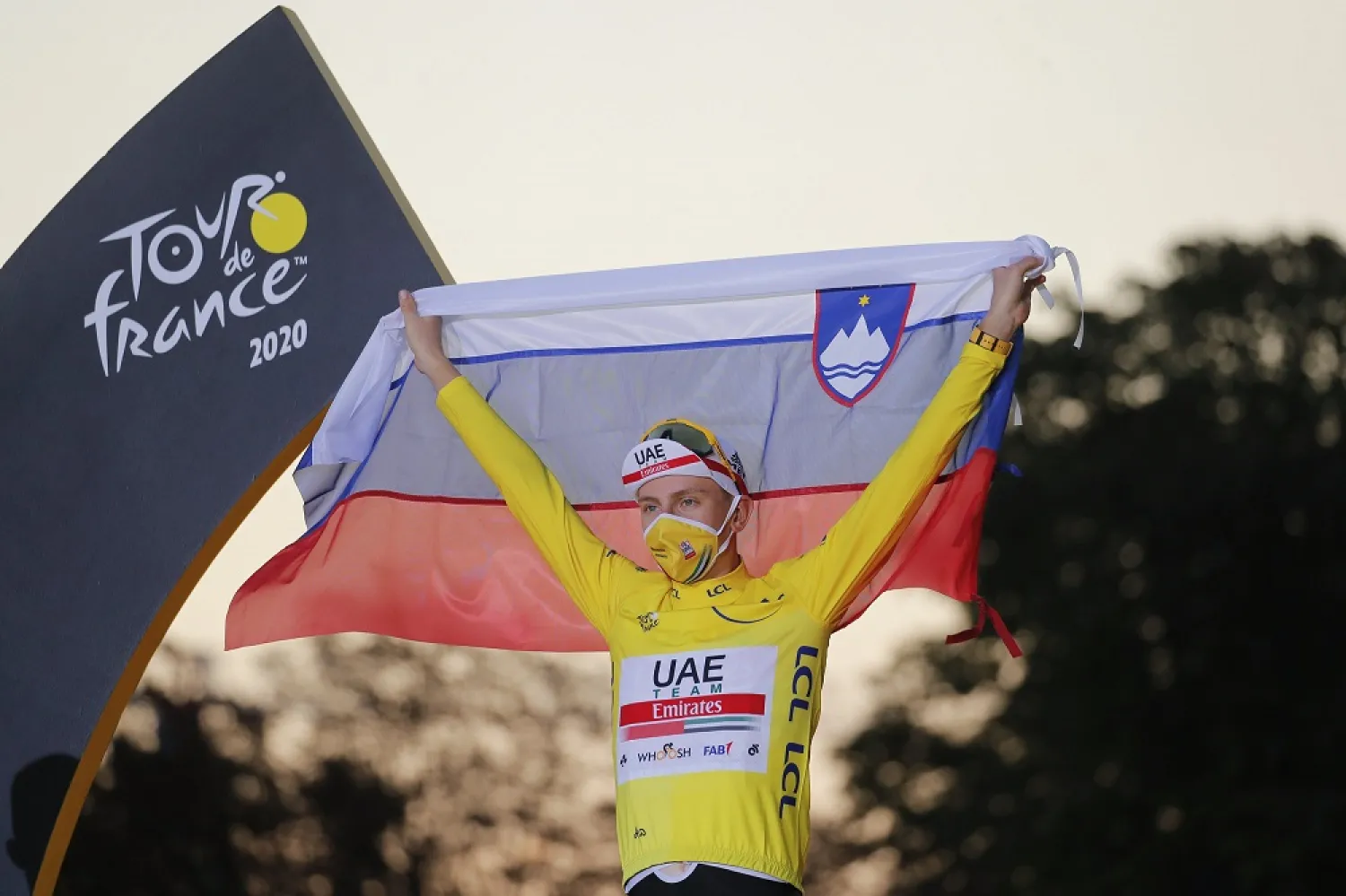 Tour de France winner Slovenia's Tadej Pogacar celebrates on the podium after the last stage of the Tour de France cycling race, Sunday, Sept. 20, 2020. (AP)
