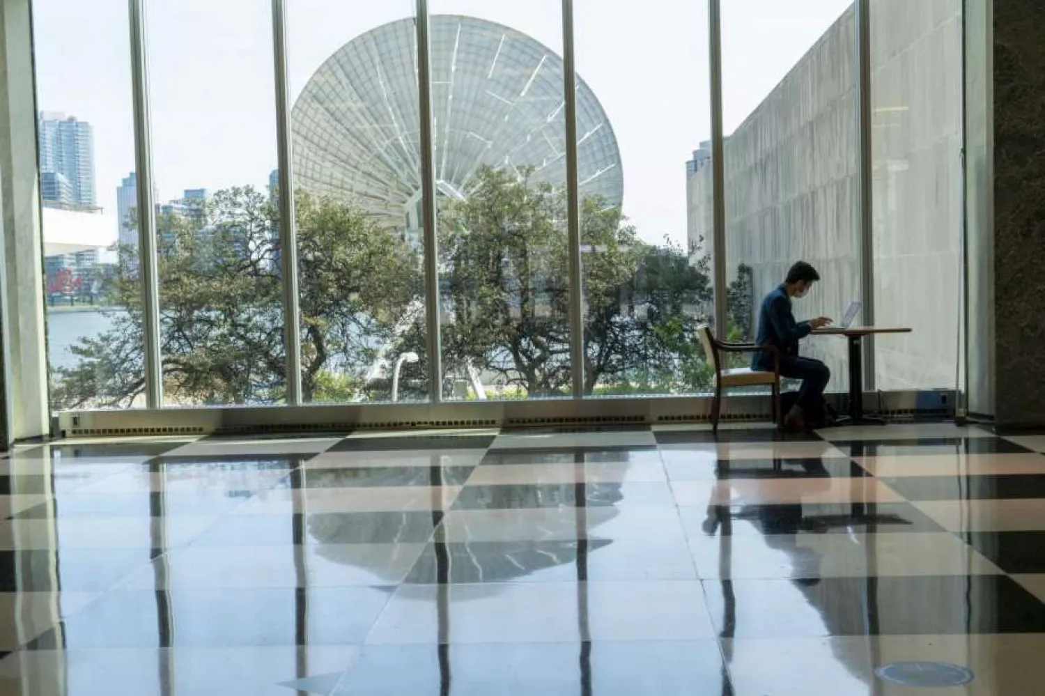 A member of the Irish delegation works on his computer in the main lobby of the United Nations headquarters, Monday, Sept. 21, 2020. (AP Photo/Mary Altaffer)