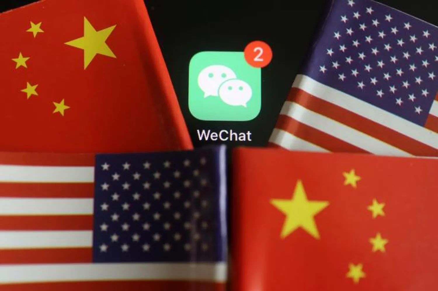 FILE PHOTO: The messenger app WeChat is seen among U.S. and China flags in this illustration picture taken Aug. 7, 2020. REUTERS/Florence Lo/Illustration