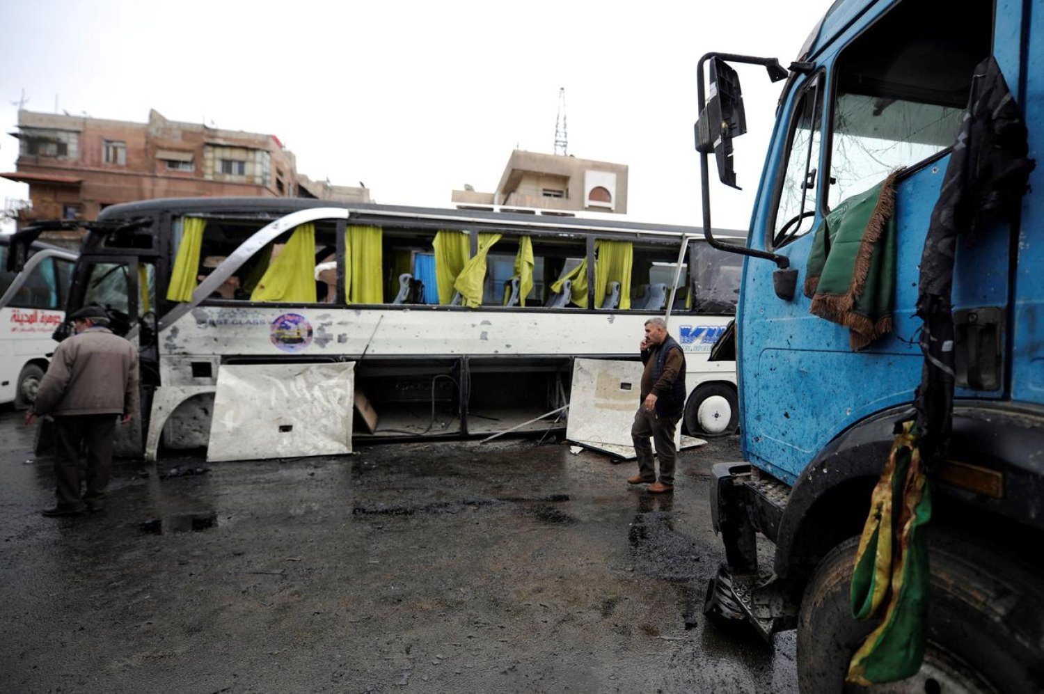 People inspect the damage at the site of an attack by two suicide bombers in Damascus, Syria. Reuters file photo
