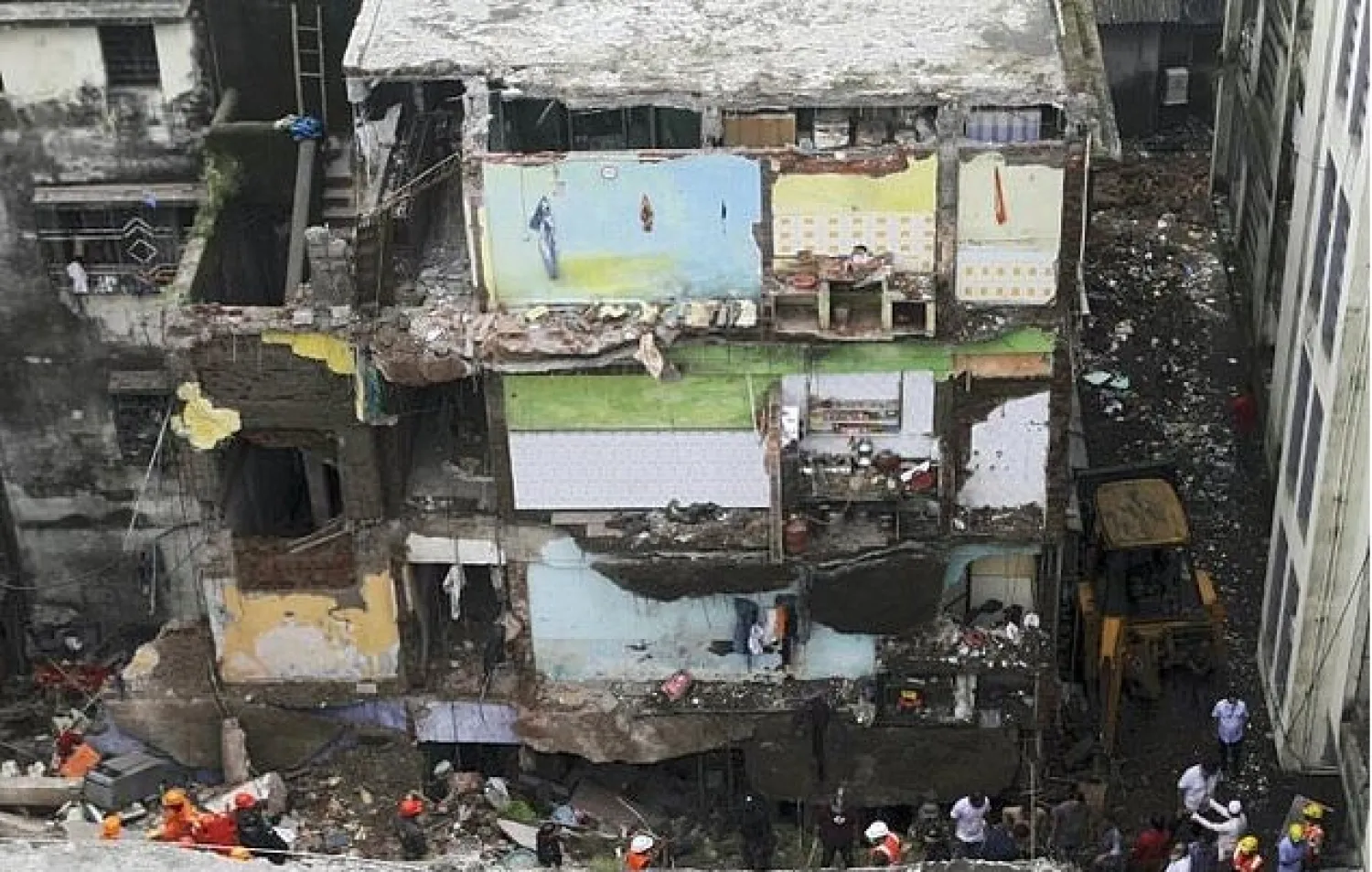 Rescue workers search for survivors in the rubble of a collapsed building in Bhiwandi, near Mumbai

