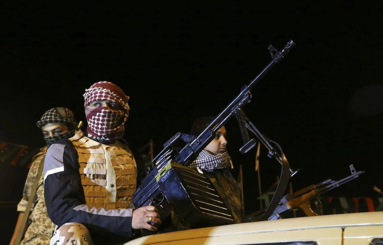 Members of an armed group hold their weapons in Libya February 18, 2014. REUTERS/Esam Omran Al-Fetori