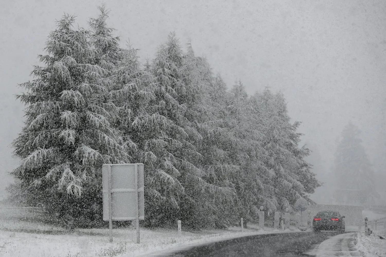 A car makes his way through heavy snow fall on motorway A 13 in Noesslach near Innsbruck, Austria, Friday, Sept. 25, 2020. (AP)