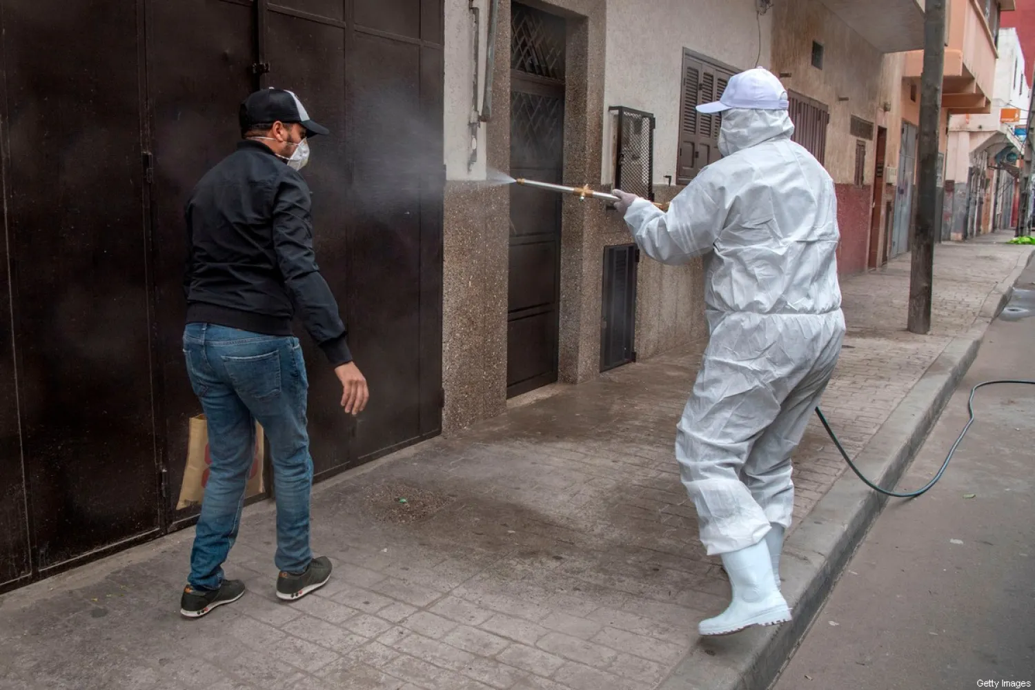 A Moroccan health ministry worker disinfects a street Rabat during the coronavirus COVID-19 pandemic. AFP file photo