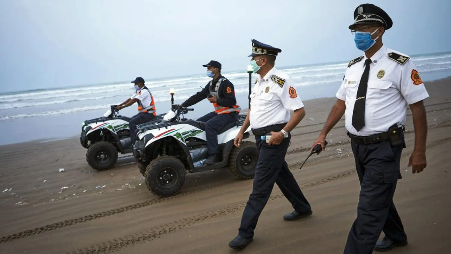 Moroccan police officers wearing face masks patrol Ain Diab beach in Casablanca, Morocco, Wednesday, Sept.23, 2020. (AP Photo/Abdeljalil Bounhar)