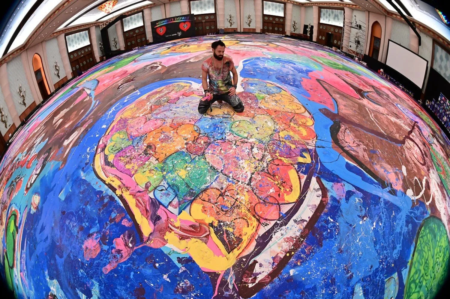 British artist Sacha Jafri aims to raise more than $30 million for children’s charities by creating the world’s largest canvas painting and auctioning it off in 60 sections. (AFP)
