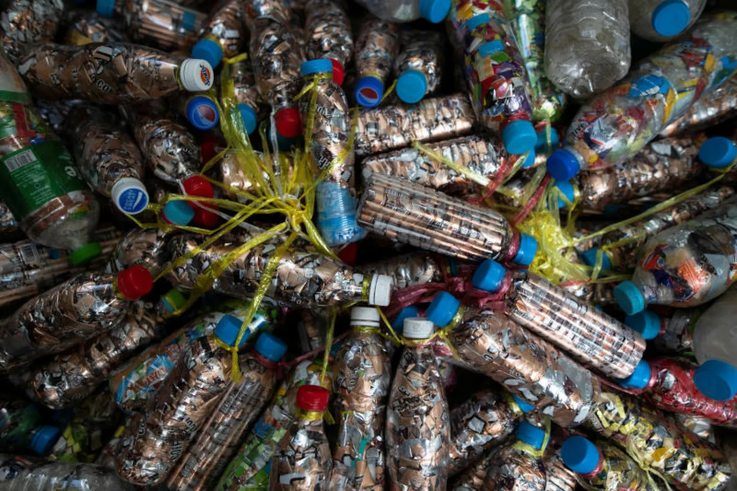 زجاجات بلاستيكية معاد تدويرها مليئة بالأكياس موجودة بمركز ثاباروا للتأمل في ميانمار (رويترز)