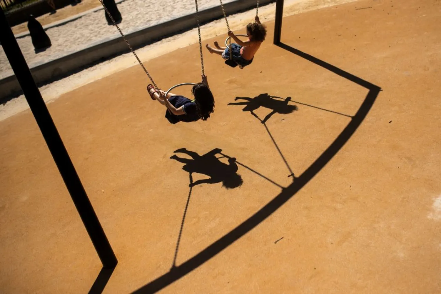 In this Thursday, May 28, 2020 file photo, children swing in a playground at Leopold park during the partial lifting of coronavirus, COVID-19, lockdown regulations in Brussels. The European Union's external auditor said Tuesday, Sept. 29, 2020 that child poverty has reached worrying levels across the world's largest economy, and has become an unacceptable situation likely to worsen during the coronavirus pandemic. (AP Photo/Francisco Seco, File)