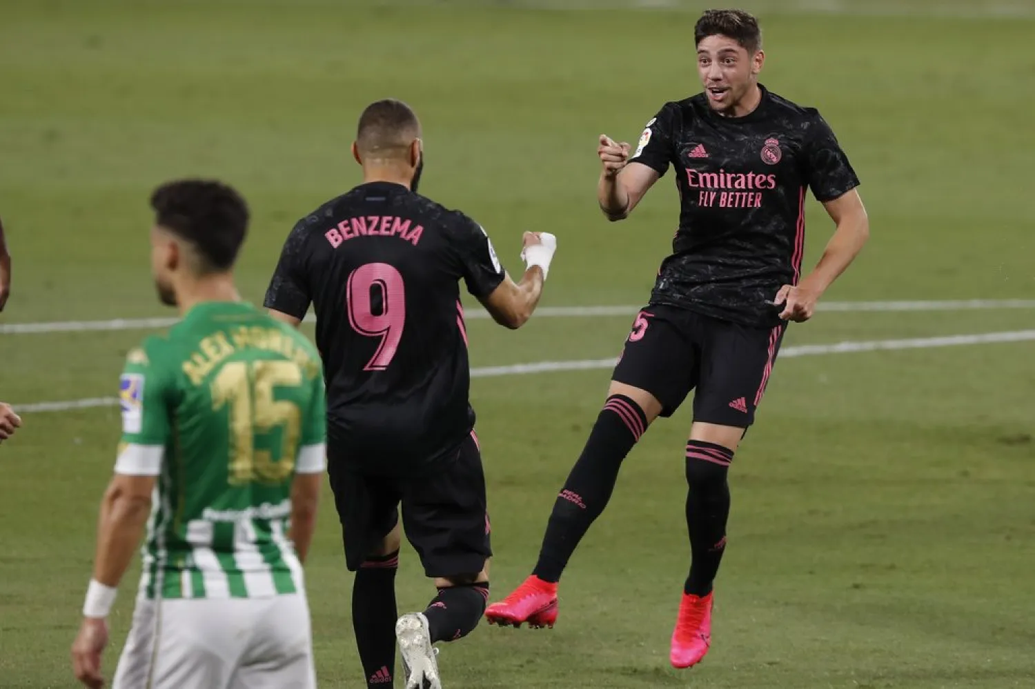 Real Madrid's Federico Valverde, right, celebrates after scoring the opening goal during the Spanish La Liga match against Betis in Seville, Spain, Saturday, Sept. 26, 2020. (AP)