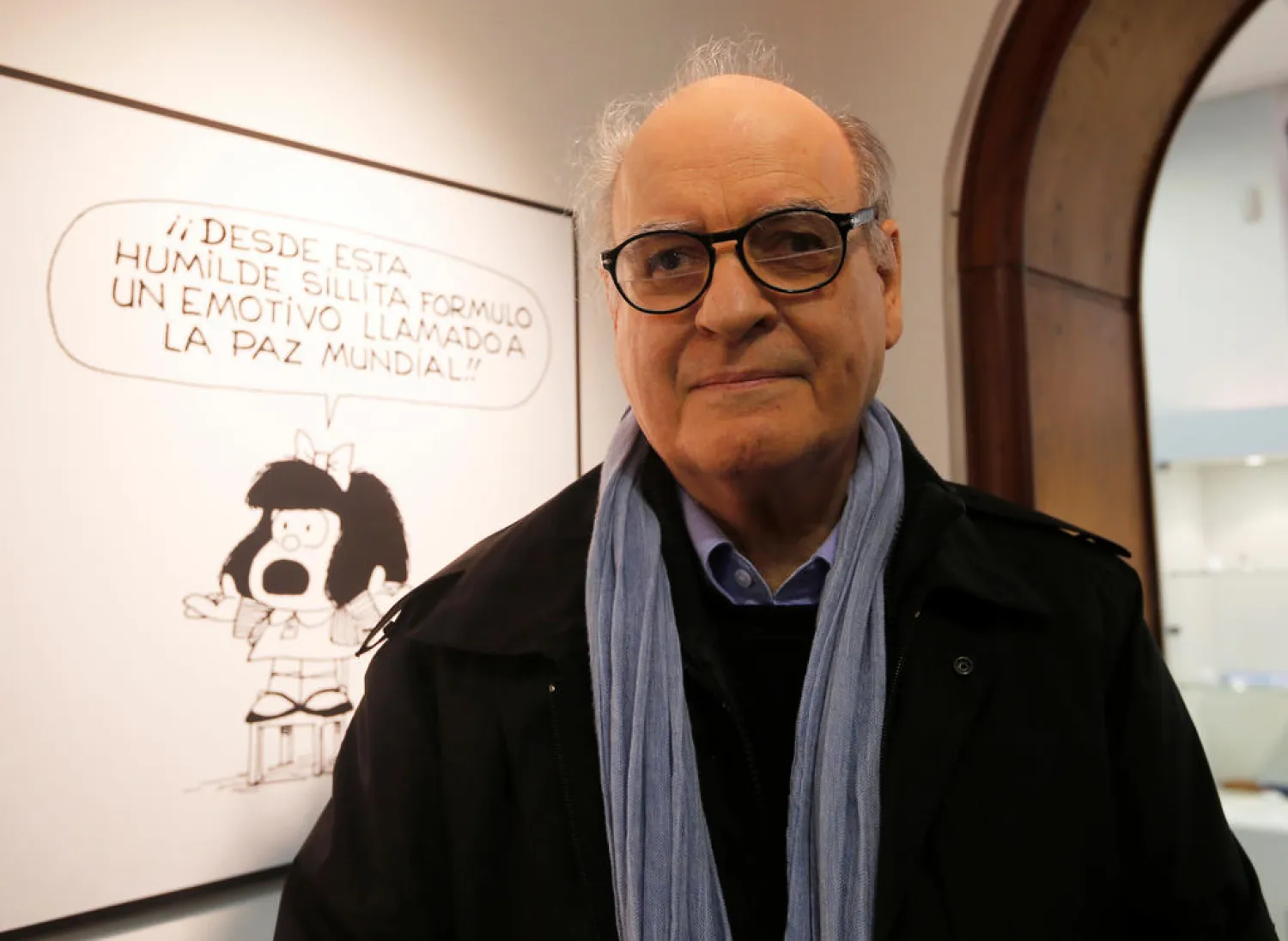 Argentine cartoonist Quino poses in front of his most famous comic character Mafalda during the opening ceremony of the exhibition of his works at the Museo del Humor in Buenos Aires. (Reuters)