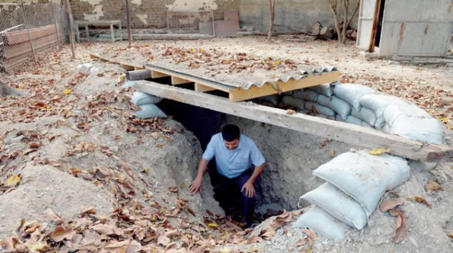 A man walks out of a makeshift bomb shelter in the village of Sahlabad outside the Azerbaijani city of Tartar on September 29, 2020. (Photo by Tofik BABAYEV / AFP)