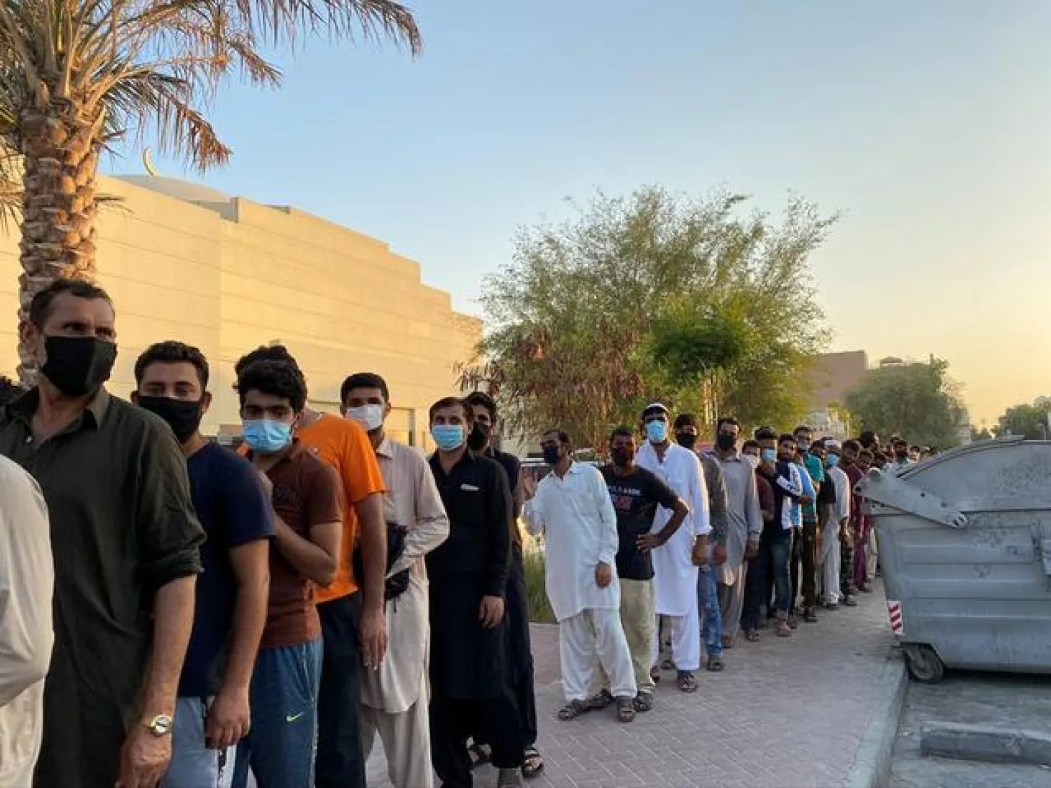 Unemployed men queue for food handouts from concerned local residents after they lost incomes due to the coronavirus disease (COVID-19) pandemic in Dubai, United Arab Emirates July 6, 2020. Picture taken July 6, 2020. REUTERS/Lisa Barrington