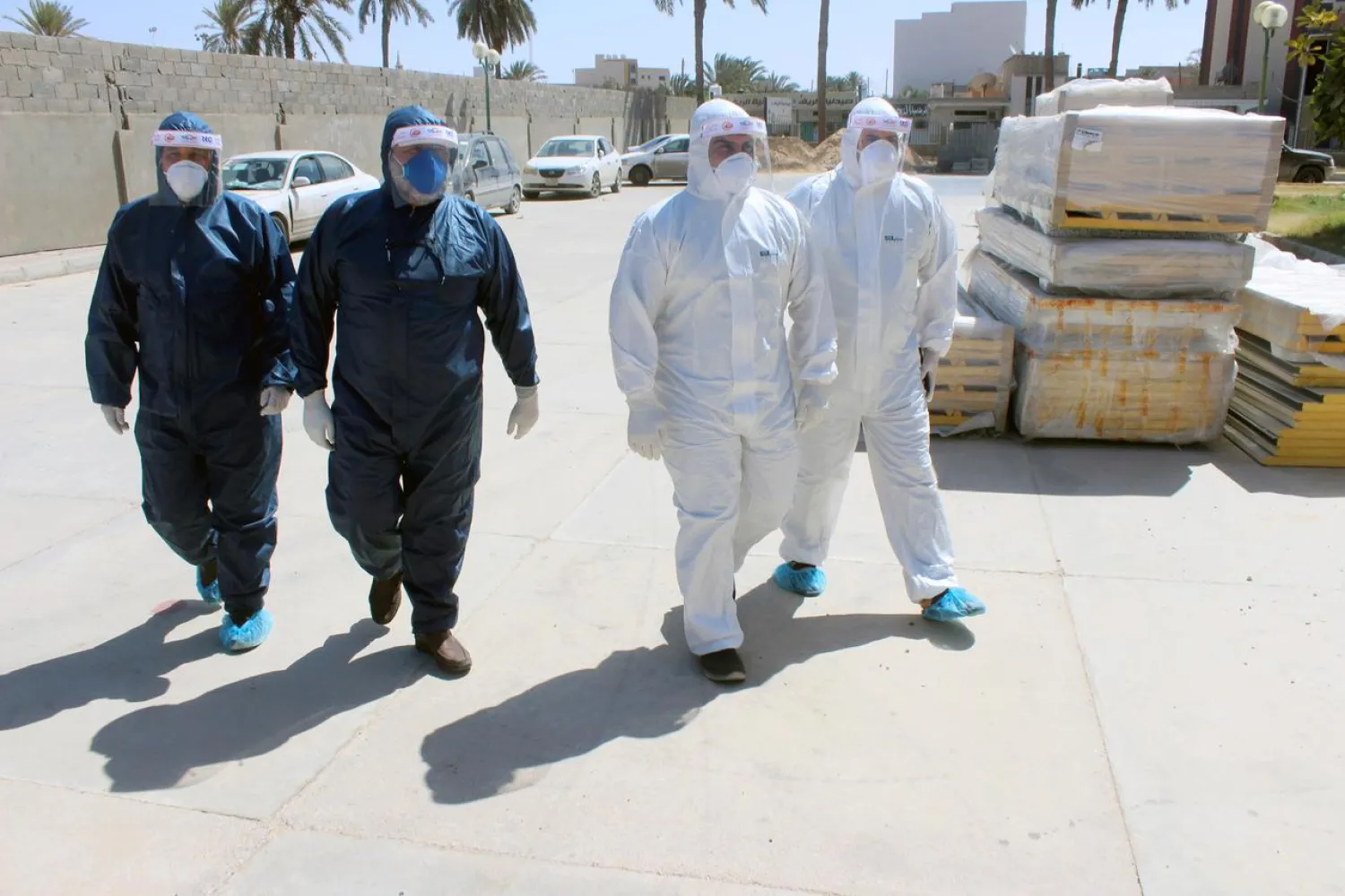 Medical team wearing protective suits walk to a clinic, following the outbreak of the coronavirus disease (COVID-19), in Misrata, Libya May 29, 2020. REUTERS/Ayman Al-Sahili/File Photo