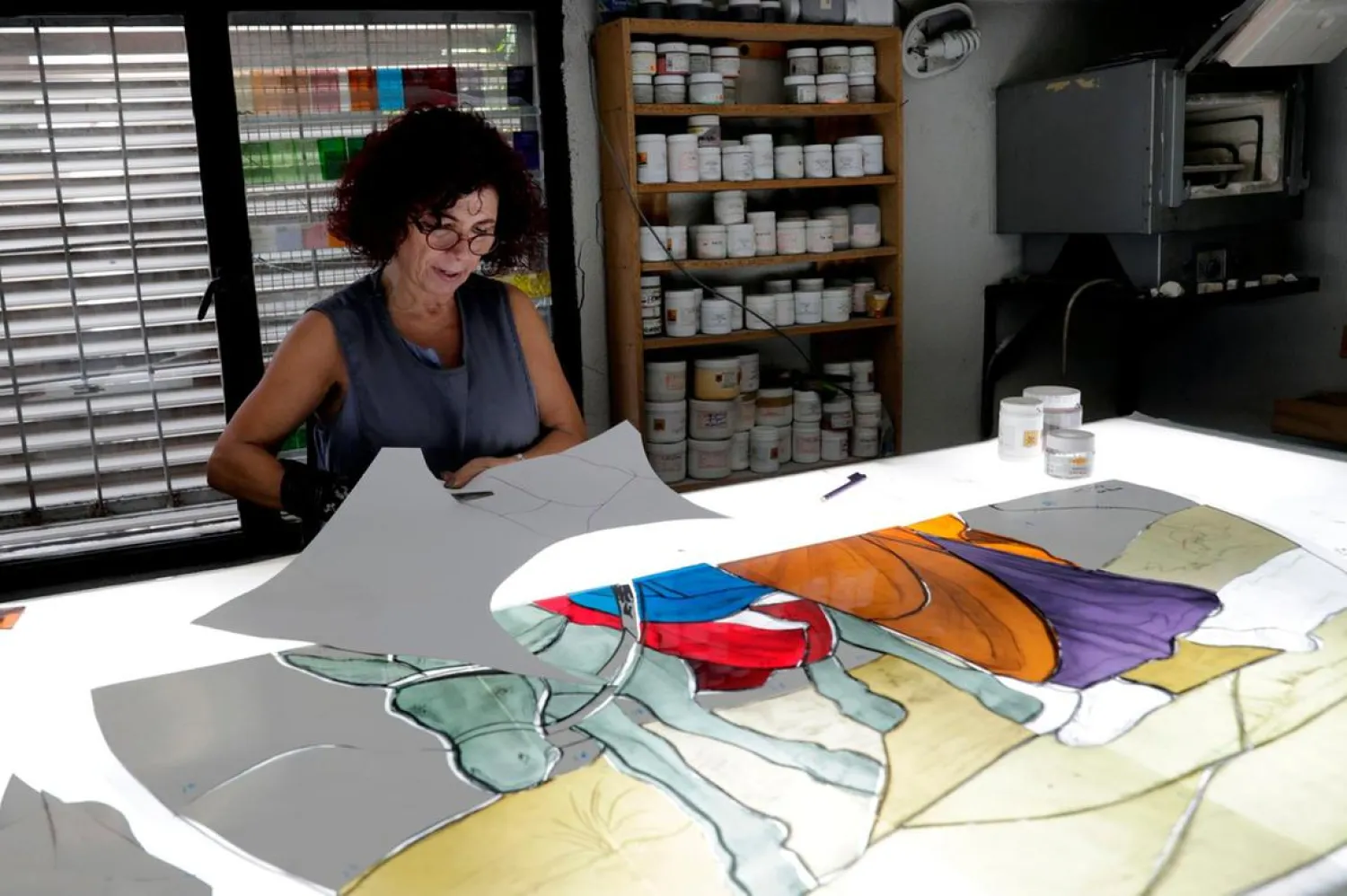 Lebanese stained glass artist Maya Husseini in her basement workshop on the outskirts of Beirut. (AFP)