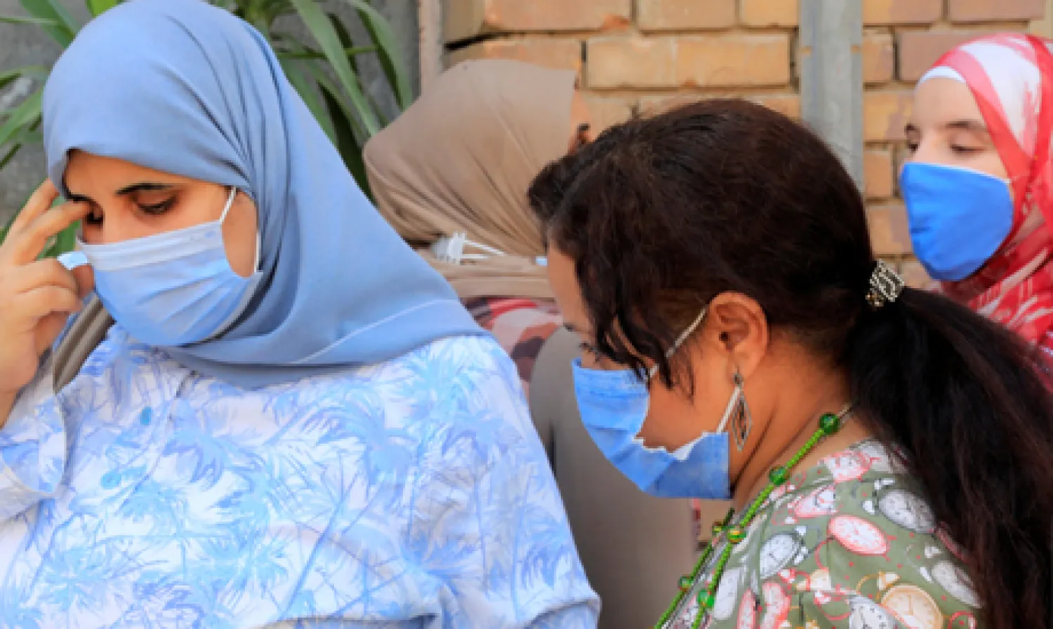 Egyptian women wearing protective face masks wait to ride a bus in a station, amid the coronavirus disease (COVID-19) pandemic in Cairo, Egypt September 15, 2020. REUTERS
