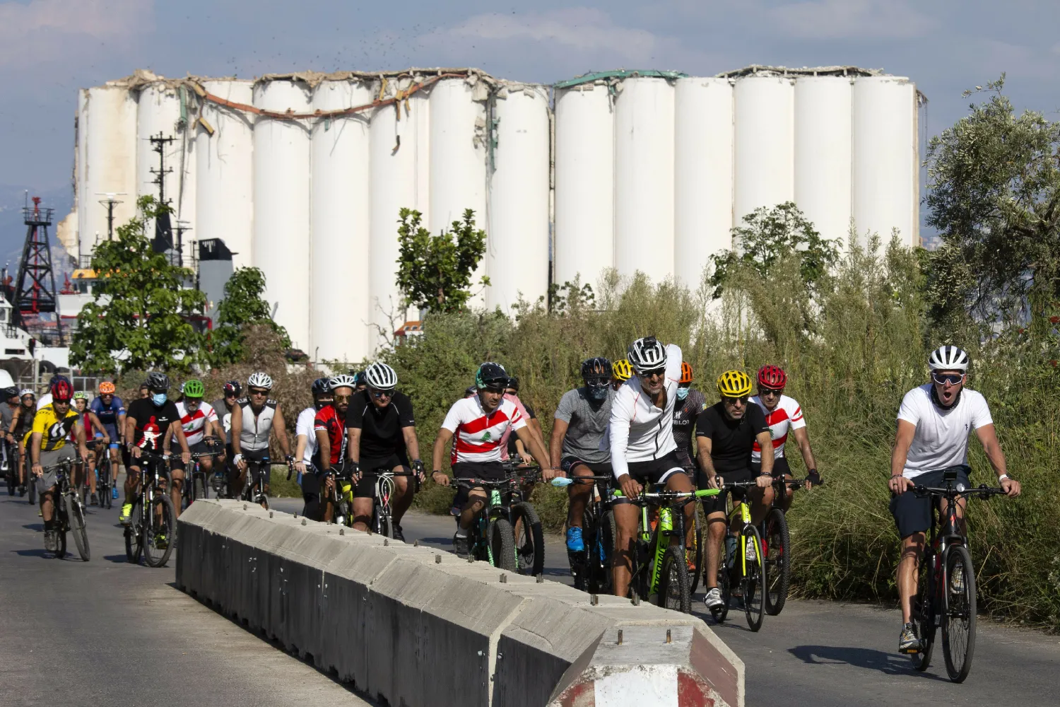 Former American professional cyclist Lance Armstrong, right, rides with Lebanese and foreign cyclists at the site of the Aug. 4 deadly blast in the port of Beirut that killed scores and wounded thousands in Beirut, Lebanon, Sunday, Oct. 4, 2020. (AP Photo/Hassan Ammar)