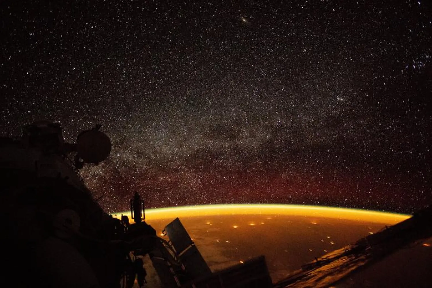 An orange hue envelops the Earth, known as "airglow," a phenomenon that occurs when ultraviolet radiation hits molecules in the atmosphere and creates a band of light that reaches 50 to 400 miles high, in this image taken on board the International Space Station (ISS), October 7, 2018. NASA/Handout via REUTERS
