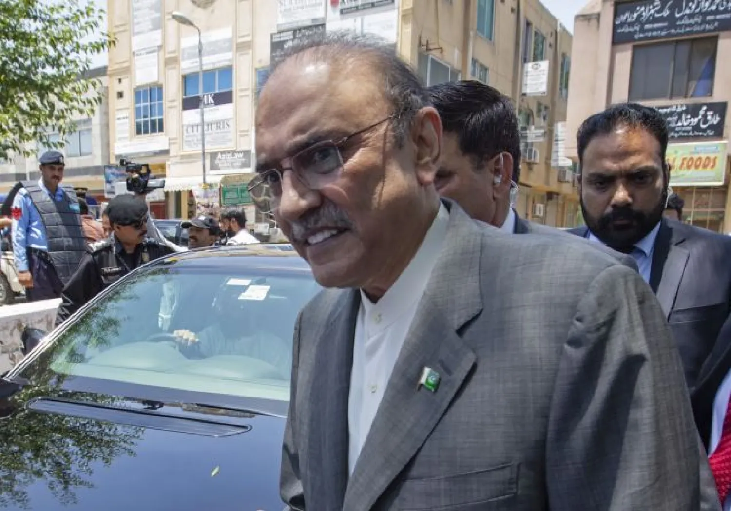 In this June 10, 2019 file photo, former Pakistani President Asif Ali Zardari leaves the High Court building, in Islamabad, Pakistan. On Monday, Oct. 5, 2020, a Pakistani court charged Zardari in two corruption cases, escalating the legal challenges facing the now leading opposition lawmaker and widower of assassinated former Pakistani Prime Minister Benazir Bhutto. The development came as Zardari's party and a key anti-government ally were preparing for a massive rally against Prime Minister Imran Khan later this month. (AP Photo/B.K. Bangash, File)