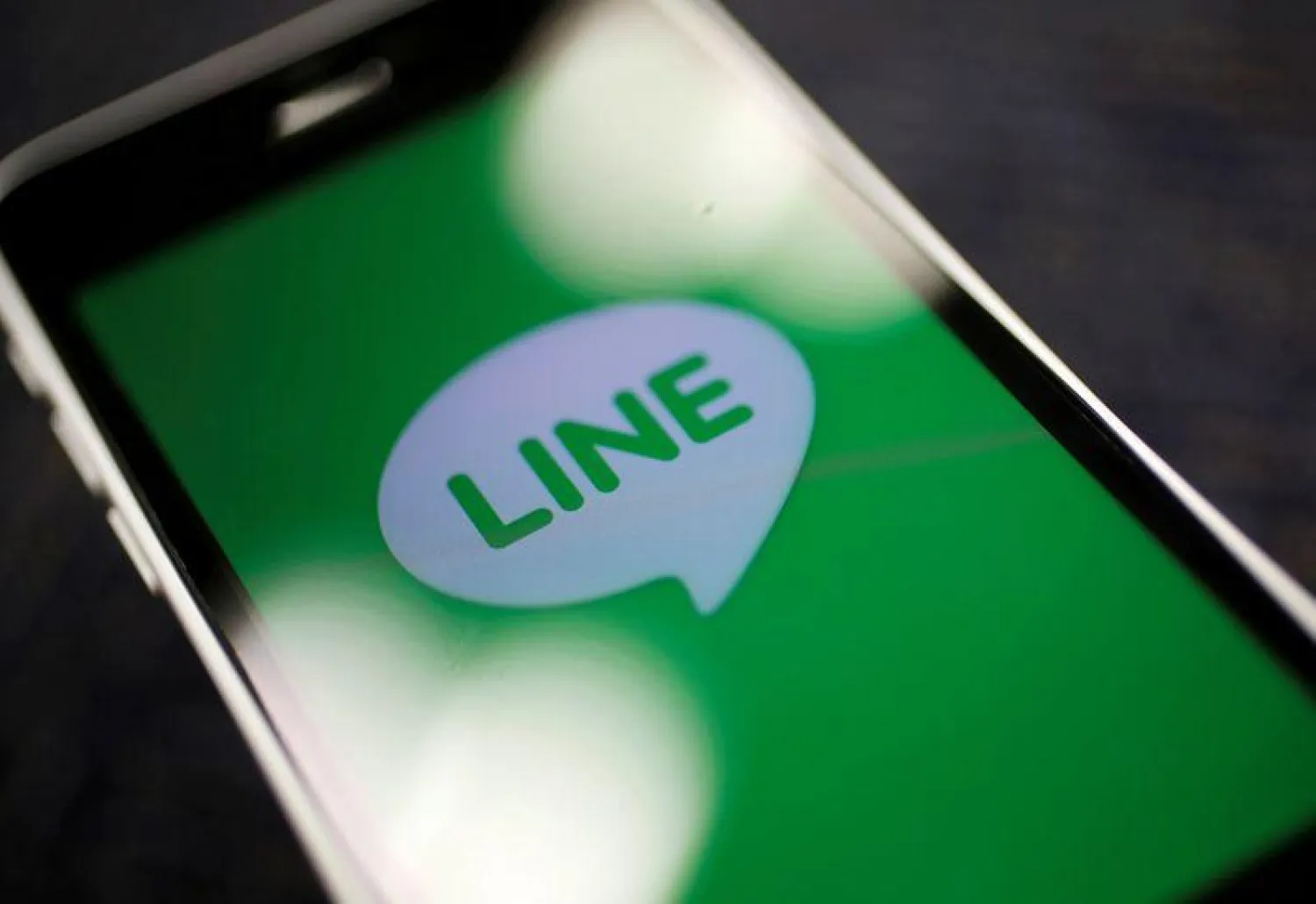 FILE PHOTO: The logo of free messaging app Line is pictured on a smartphone in this photo illustration taken in Tokyo, Japan September 23, 2014. REUTERS/Toru Hanai/File Photo
