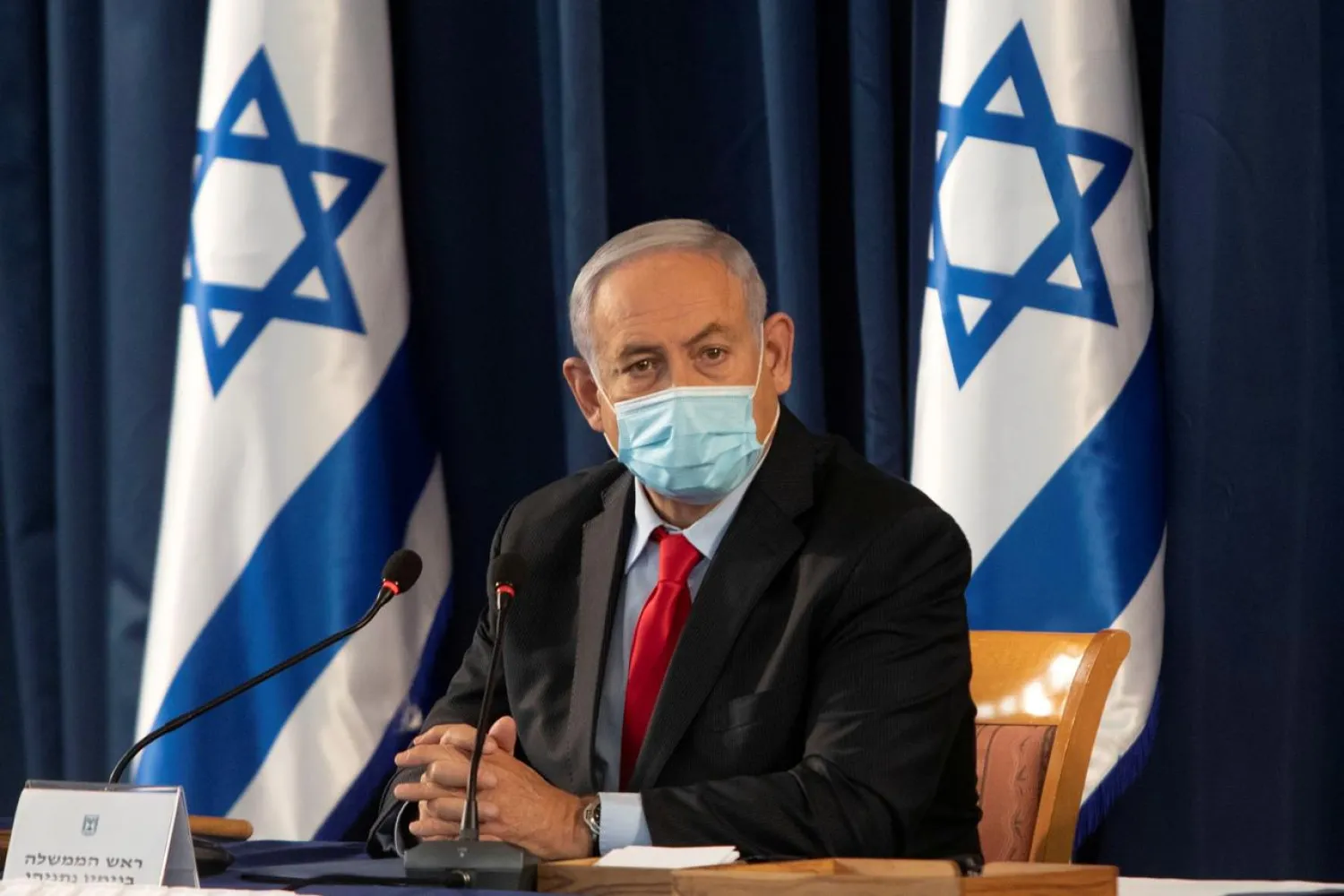 FILE PHOTO: Israeli Prime Minister Benjamin Netanyahu, wearing a protective face mask, attends the weekly cabinet meeting at the Ministry of Foreign Affairs in Jerusalem, June 14, 2020. Sebastian Scheiner/Pool via REUTERS