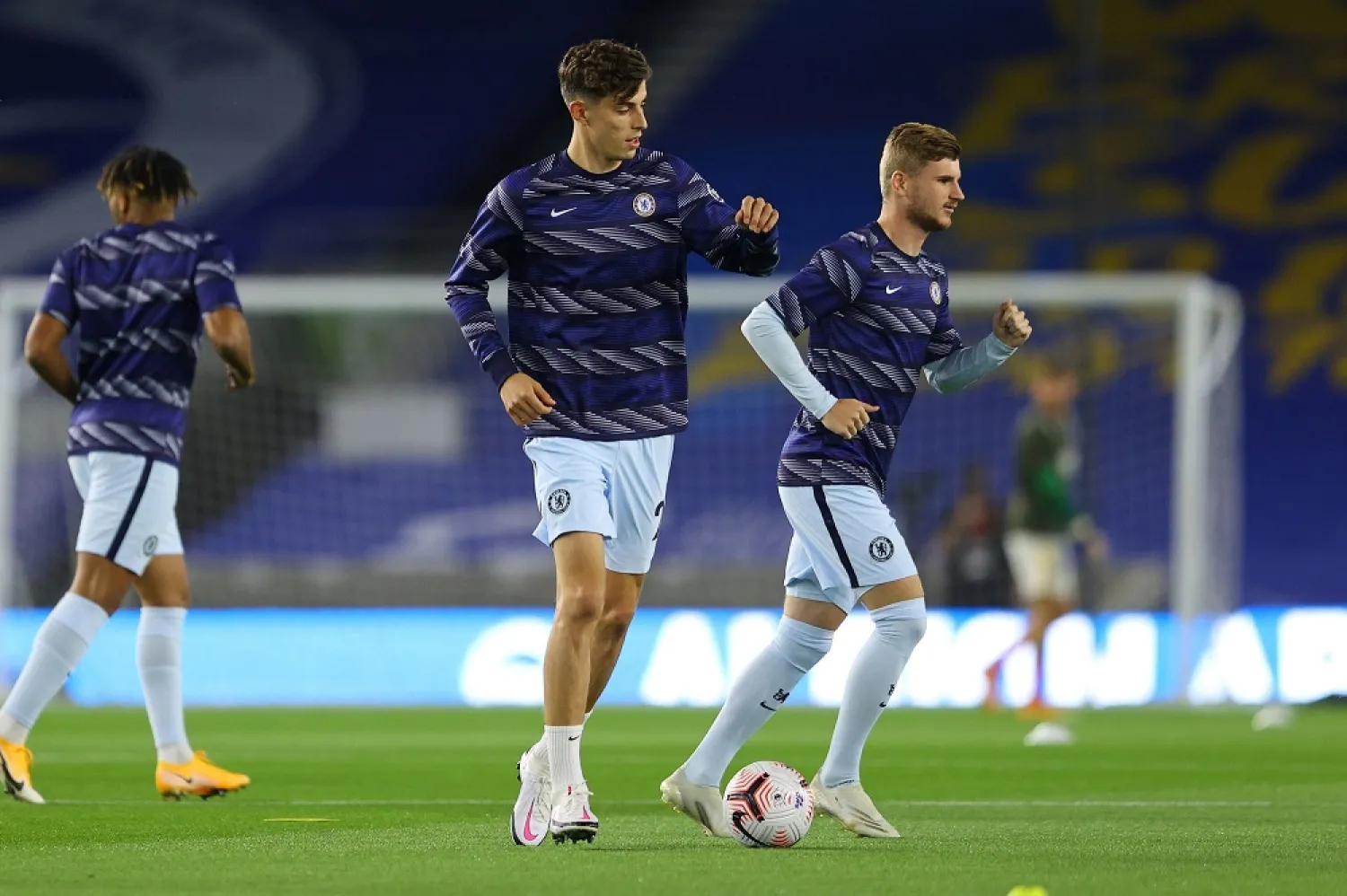 Chelsea's Kai Havertz (C) and Timo Werner (R), signed for a combined $160 million, warm up ahead of the Premier League football match against Brighton & Hove Albion, Sept. 14, 2020. (AFP)